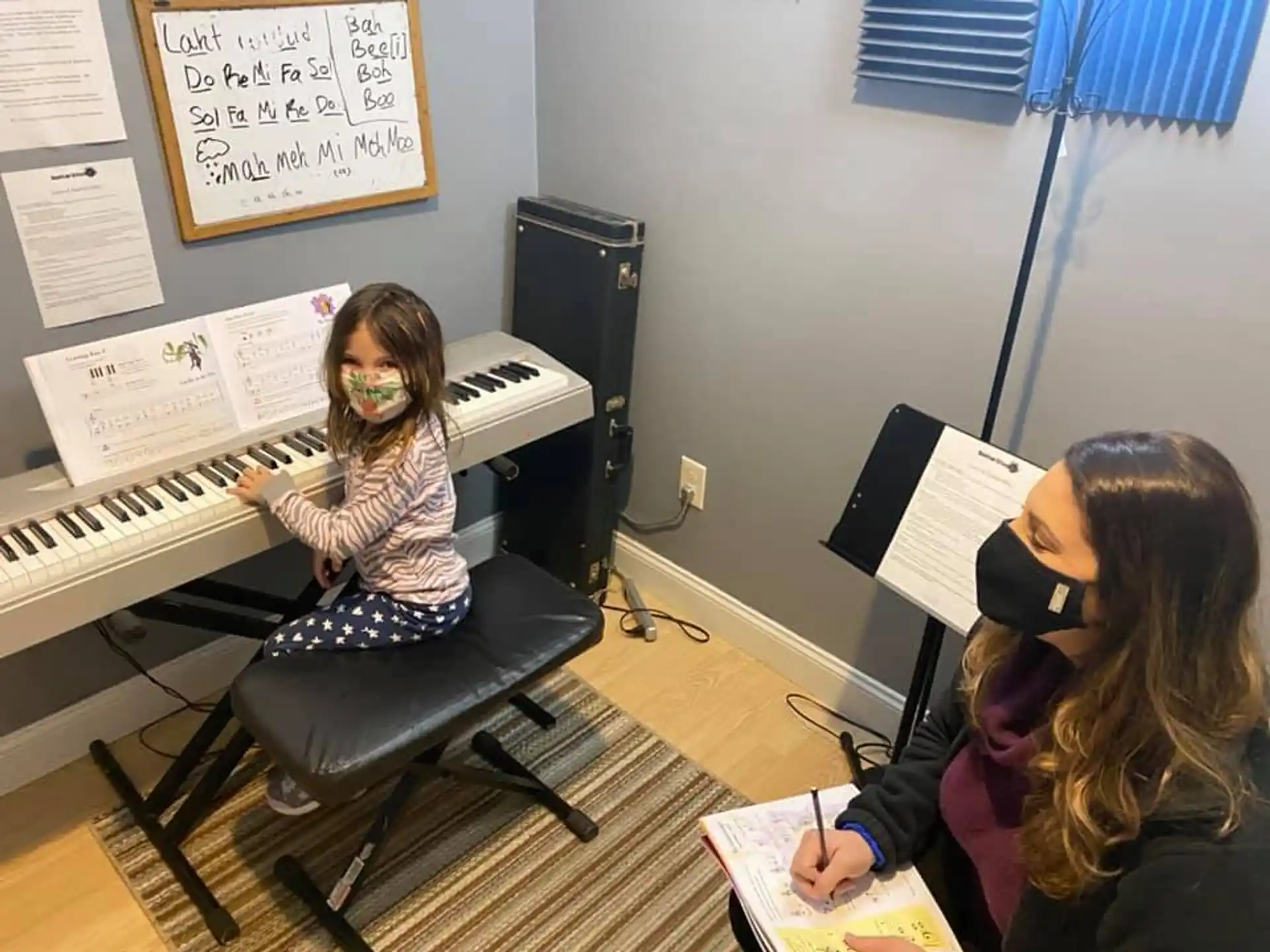 a group of people sitting at a piano