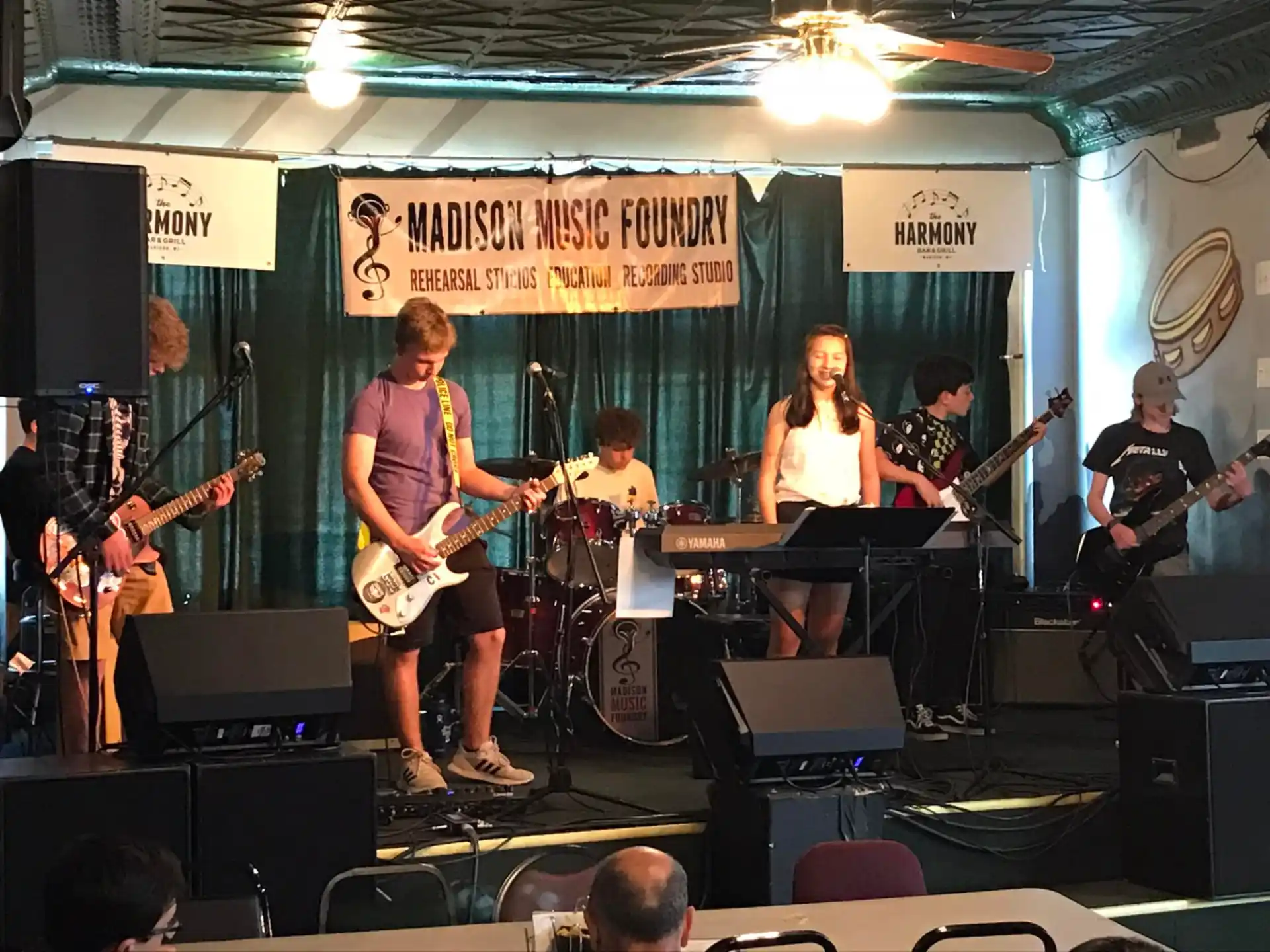 a group of people playing instruments on a stage