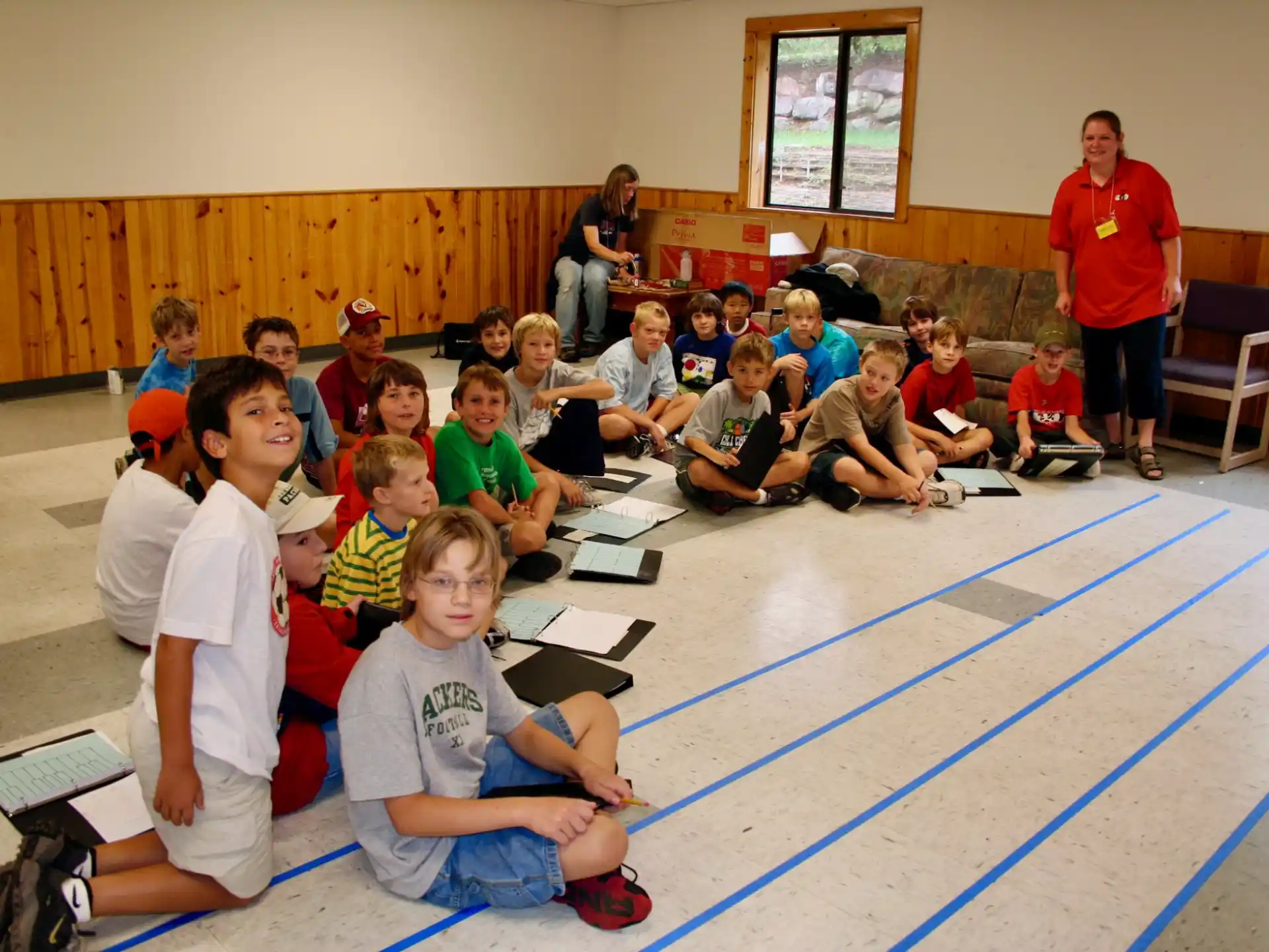 a group of children sitting on the floor in a room