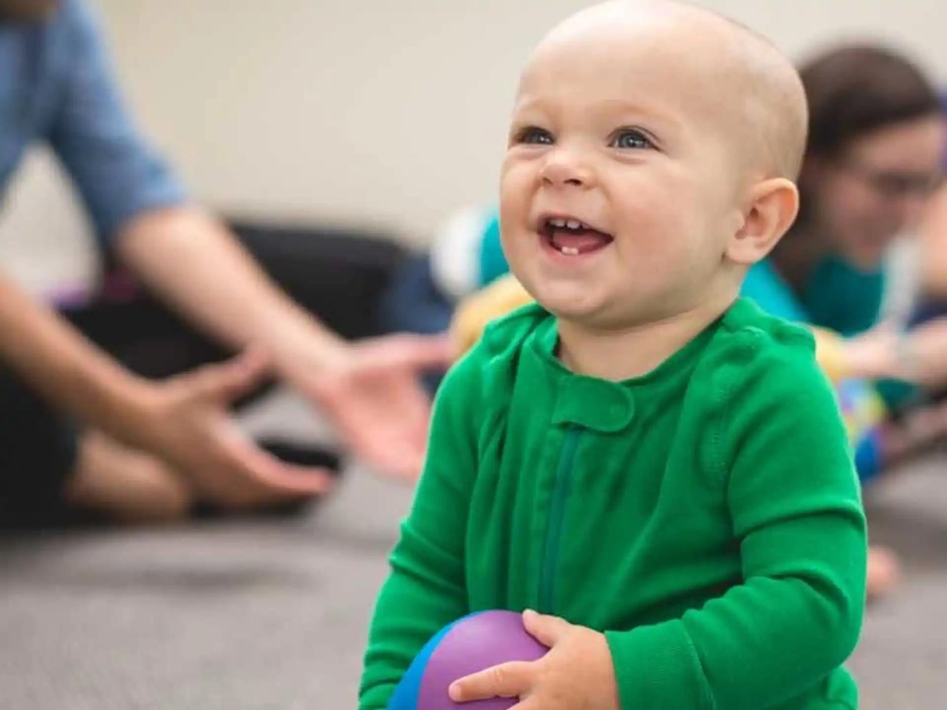 a baby holding a ball