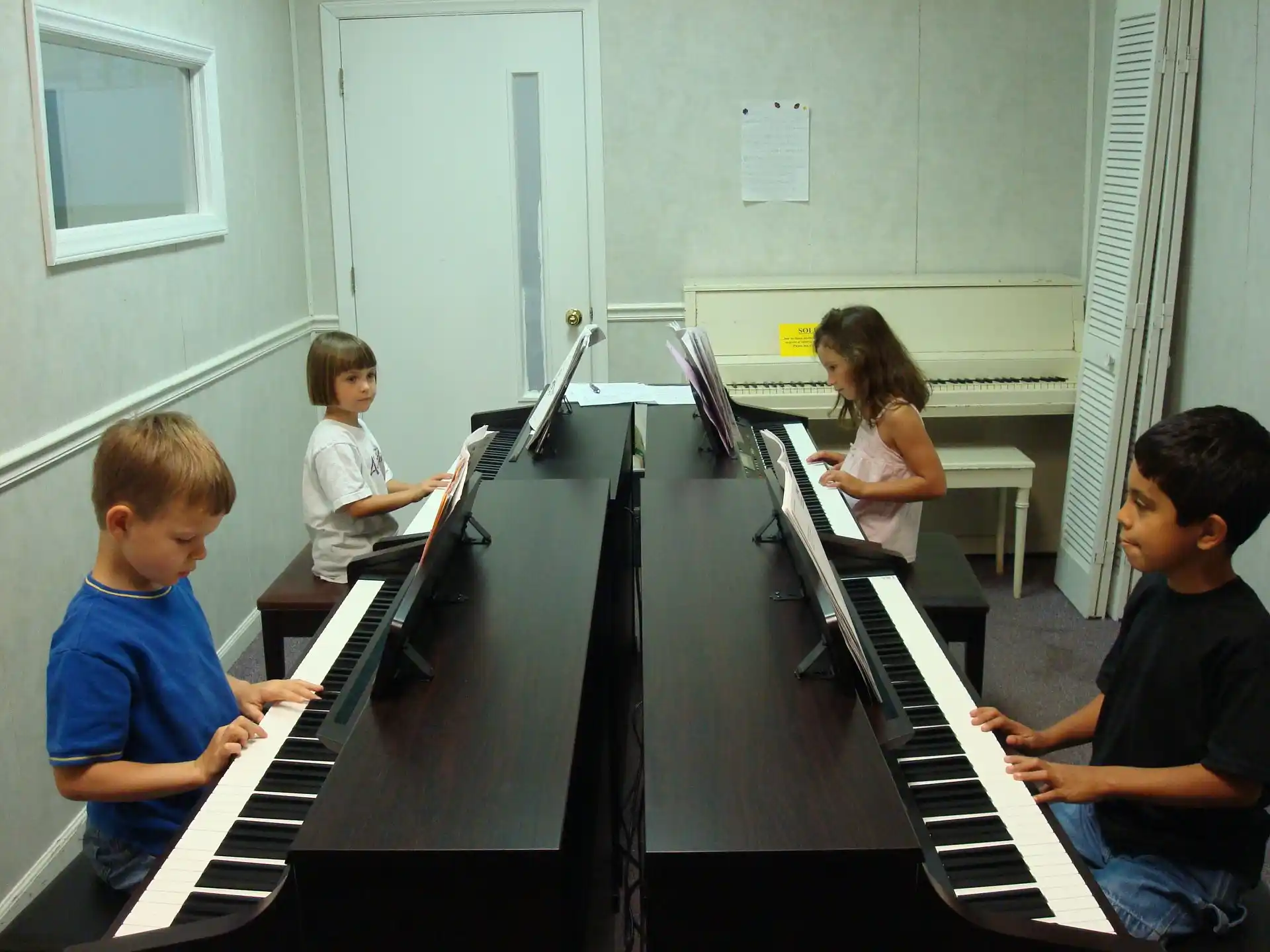 a group of kids playing piano