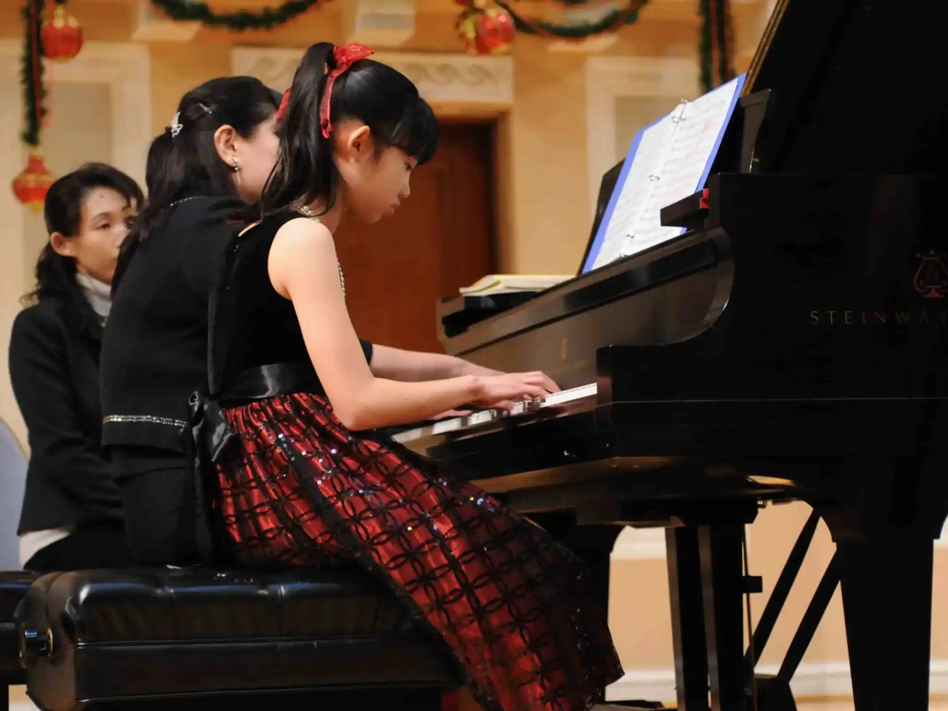 a group of women playing a piano