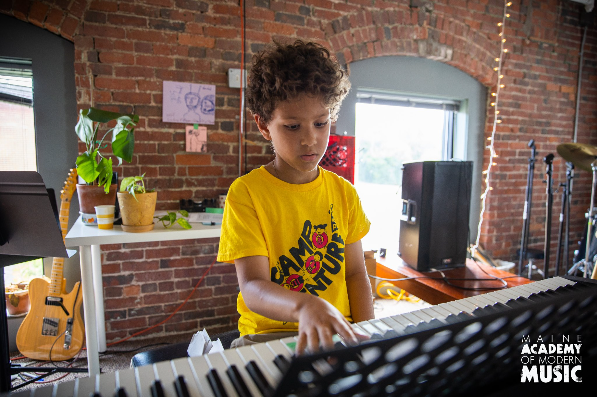 a boy playing a keyboard