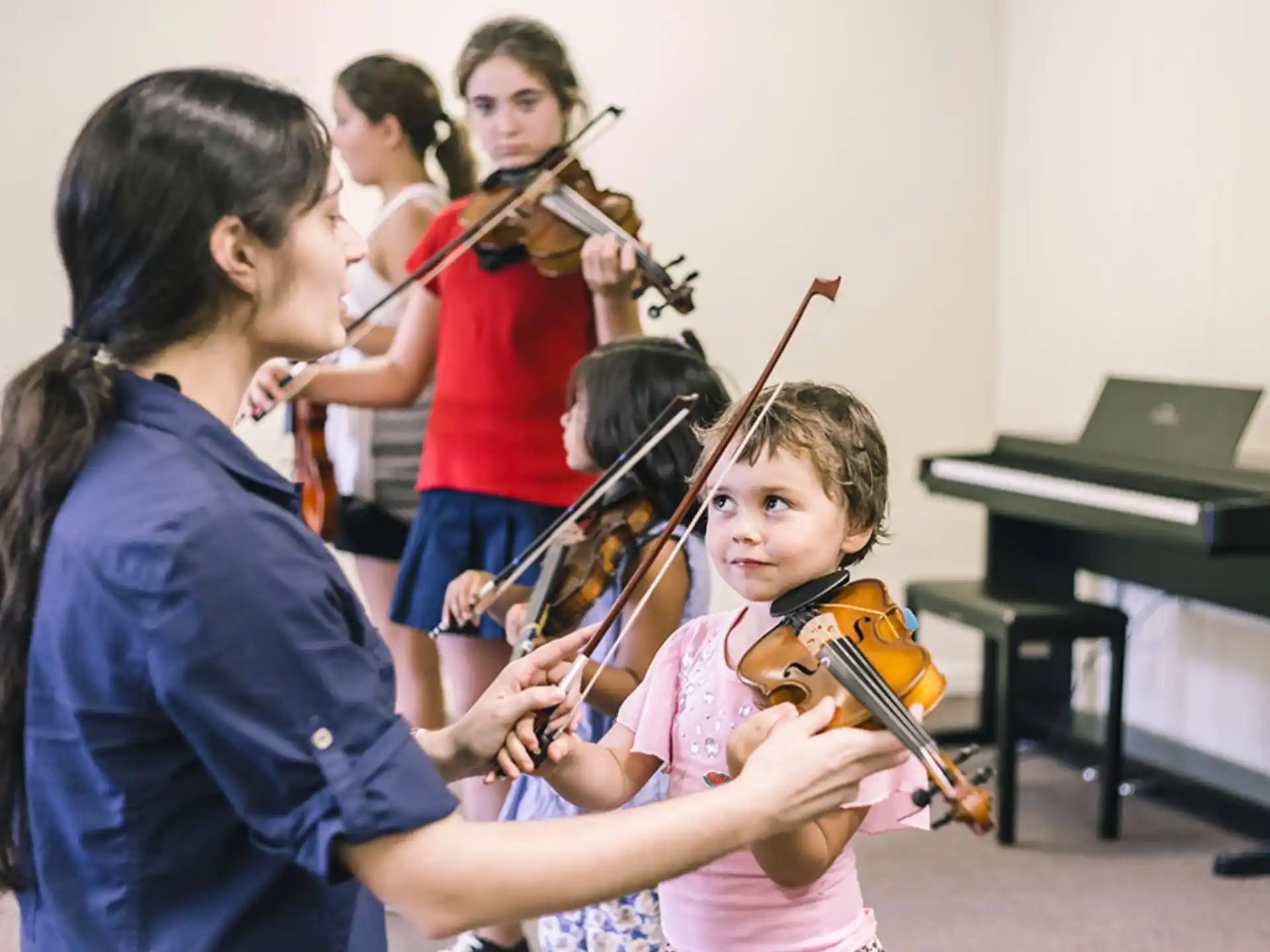 a group of people playing violin