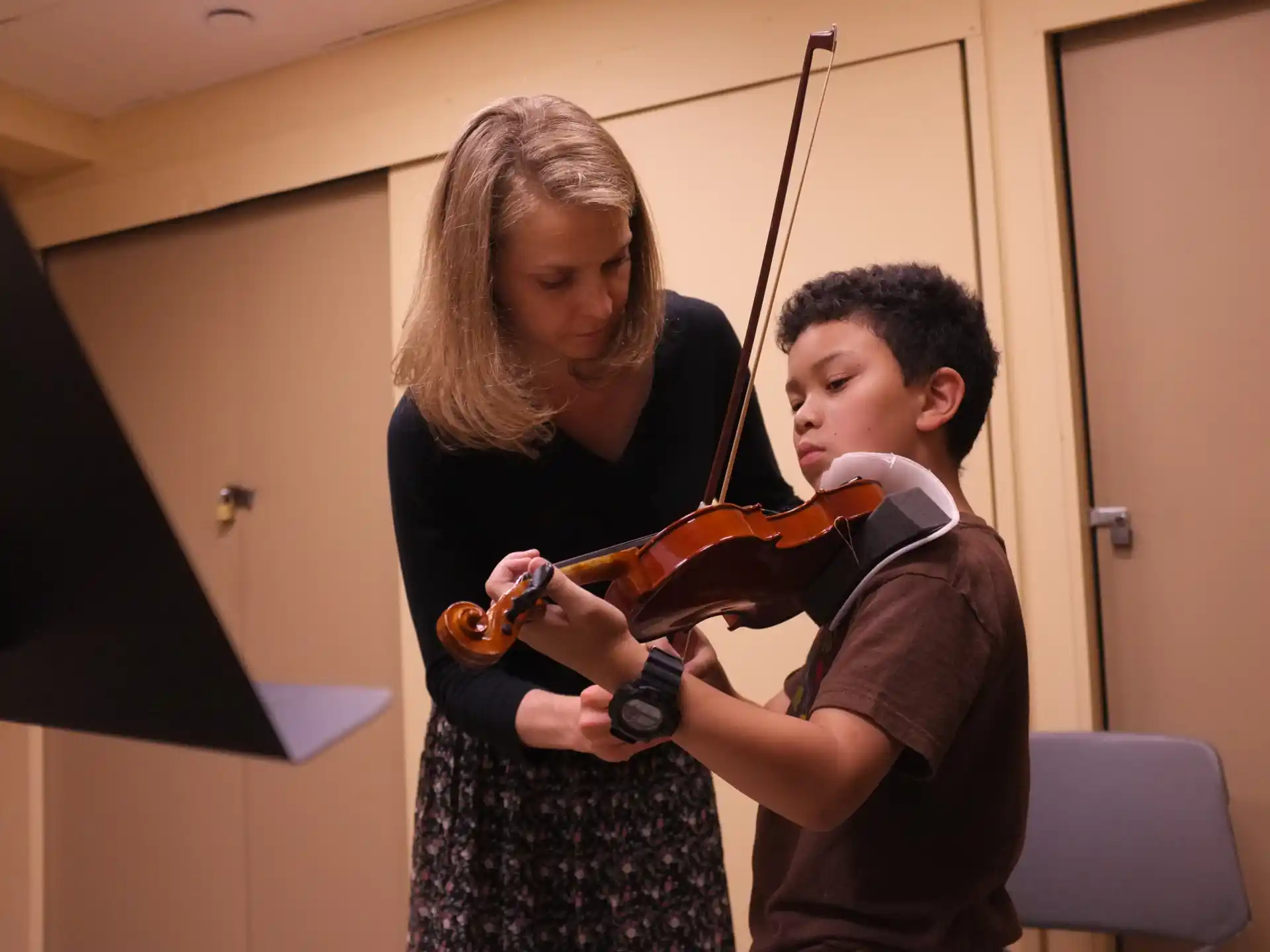 a boy and girl playing violin