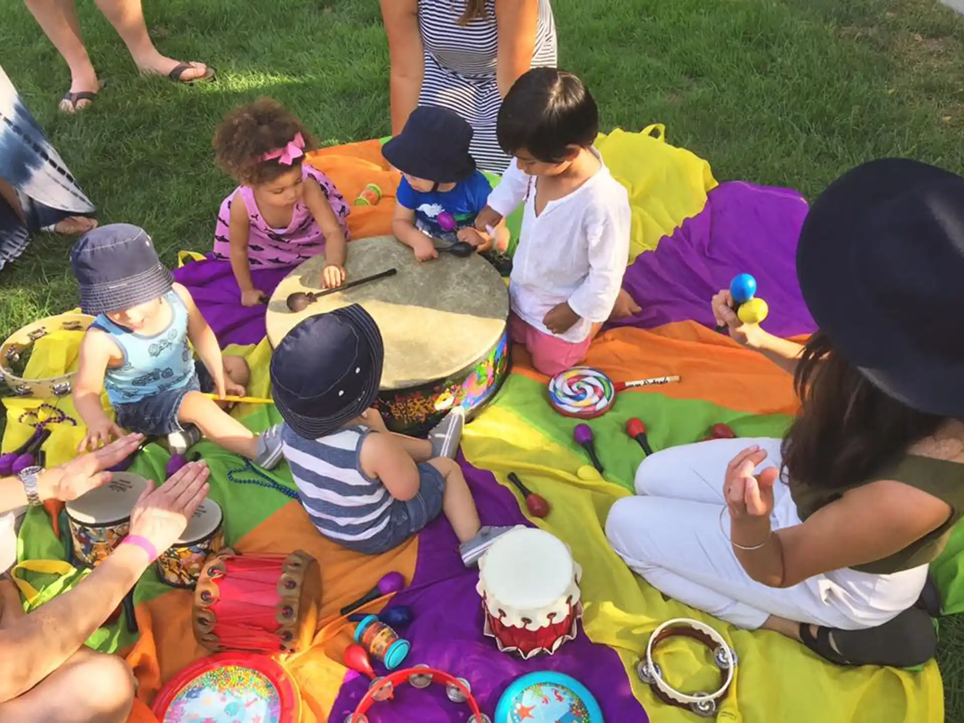 a group of children sitting on the grass
