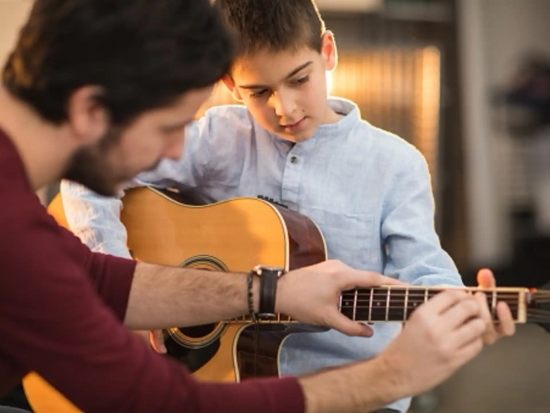 a couple of boys playing guitars