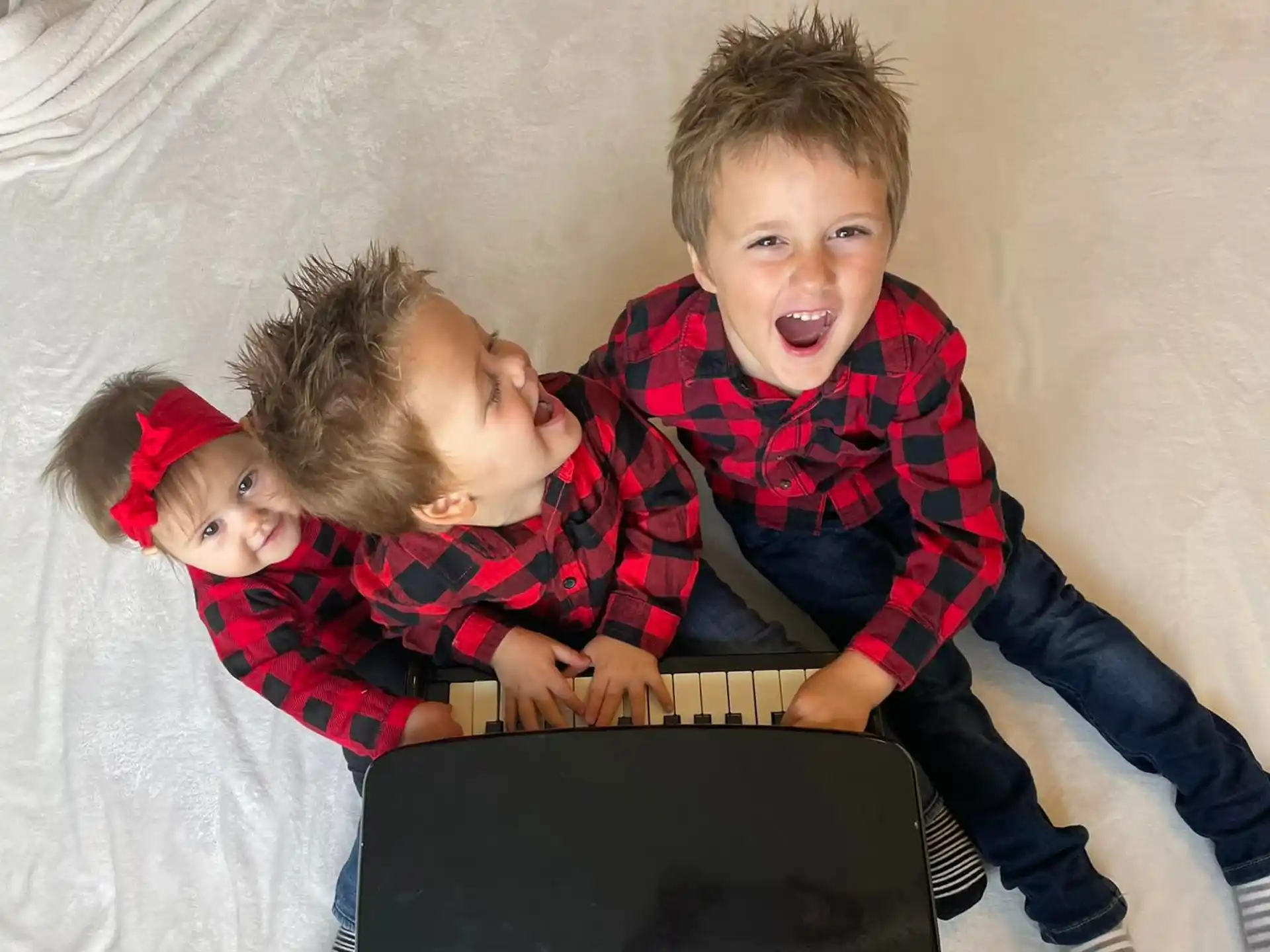 a group of children looking at a laptop