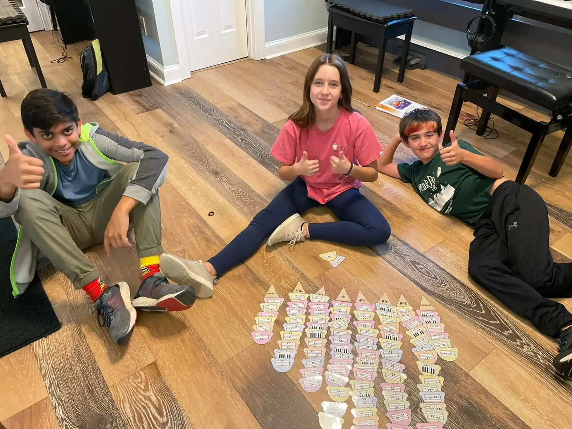 a group of people sitting on the floor playing a board game