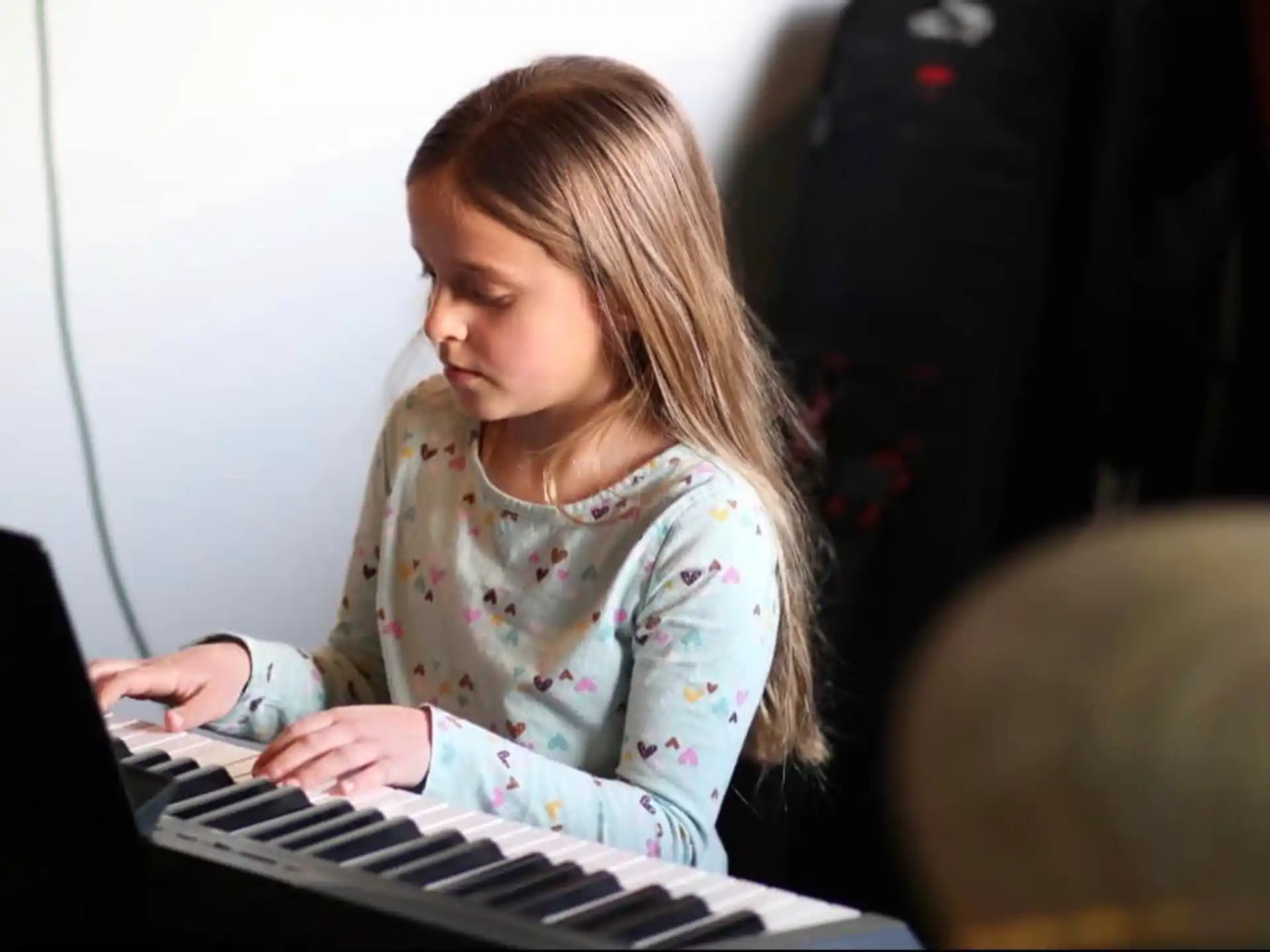 a girl playing a piano