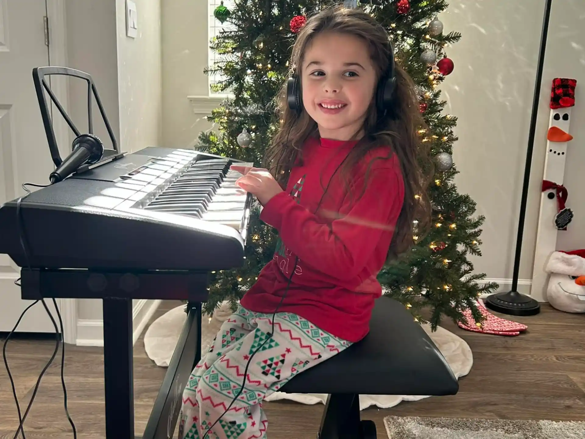 a girl sitting at a piano