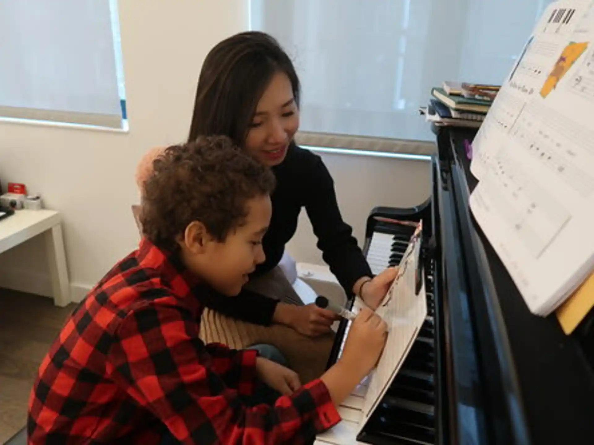 a person and a boy looking at a computer screen