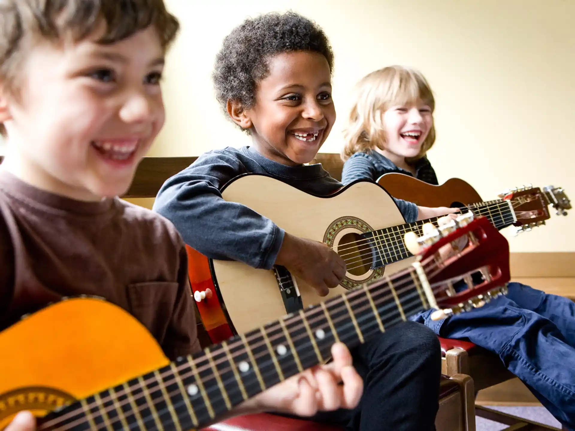 a group of kids playing guitars