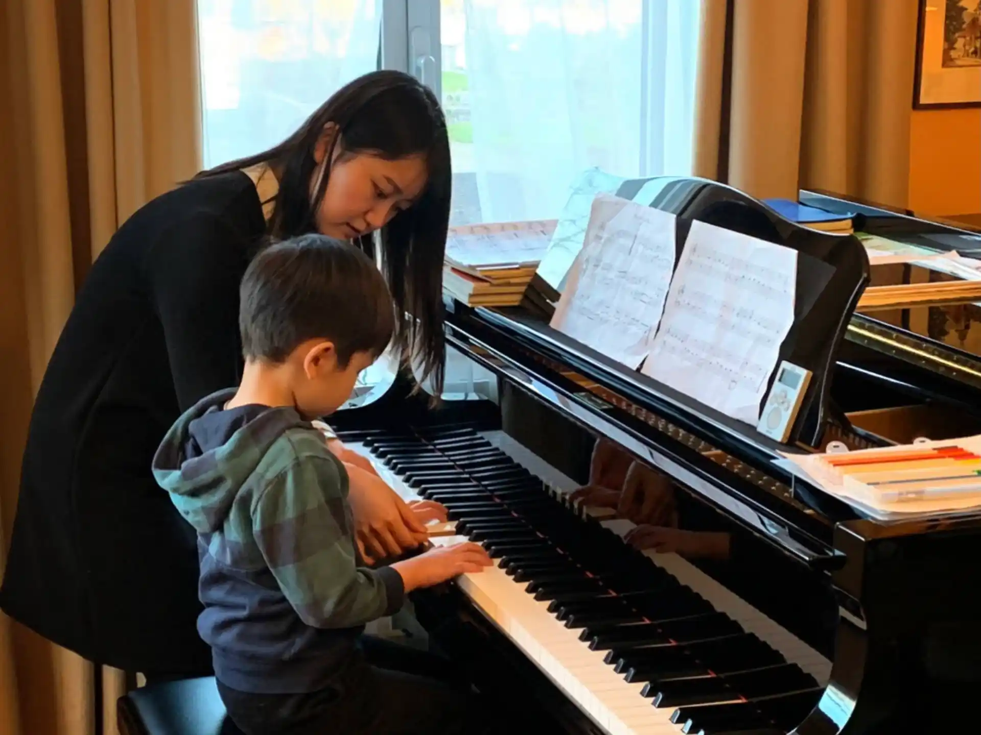 a person and a child playing piano