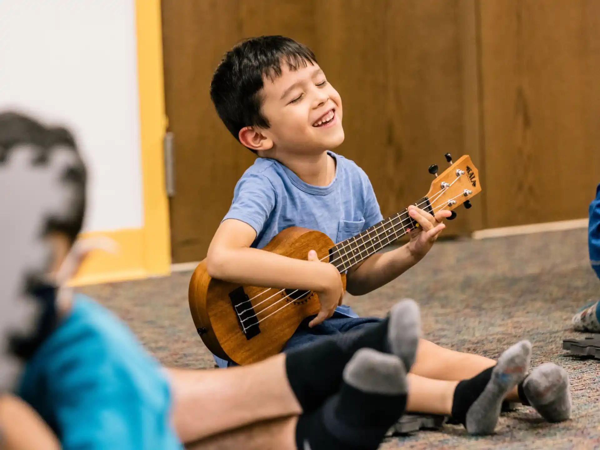 a boy playing a guitar