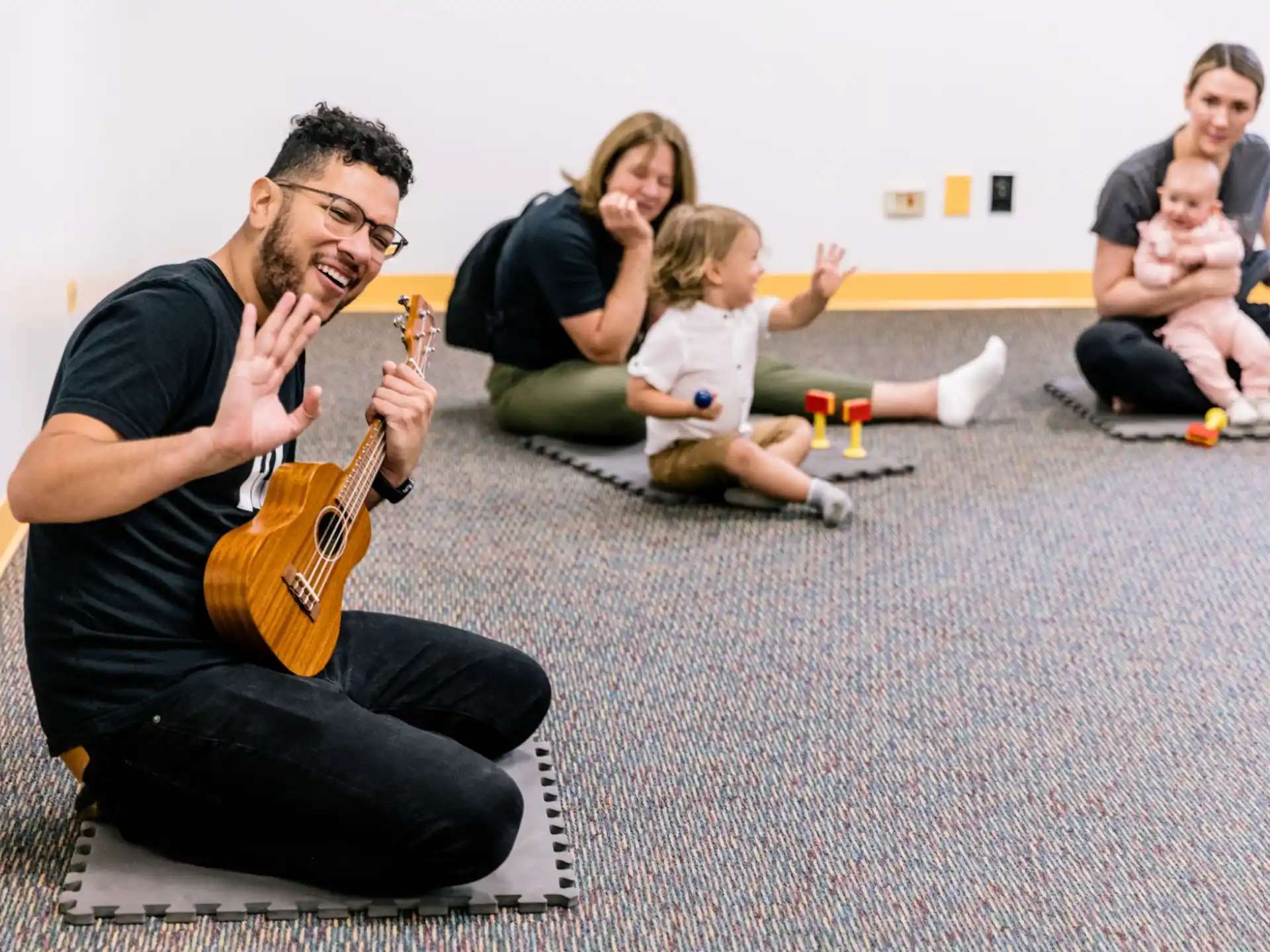 a man playing guitar with kids