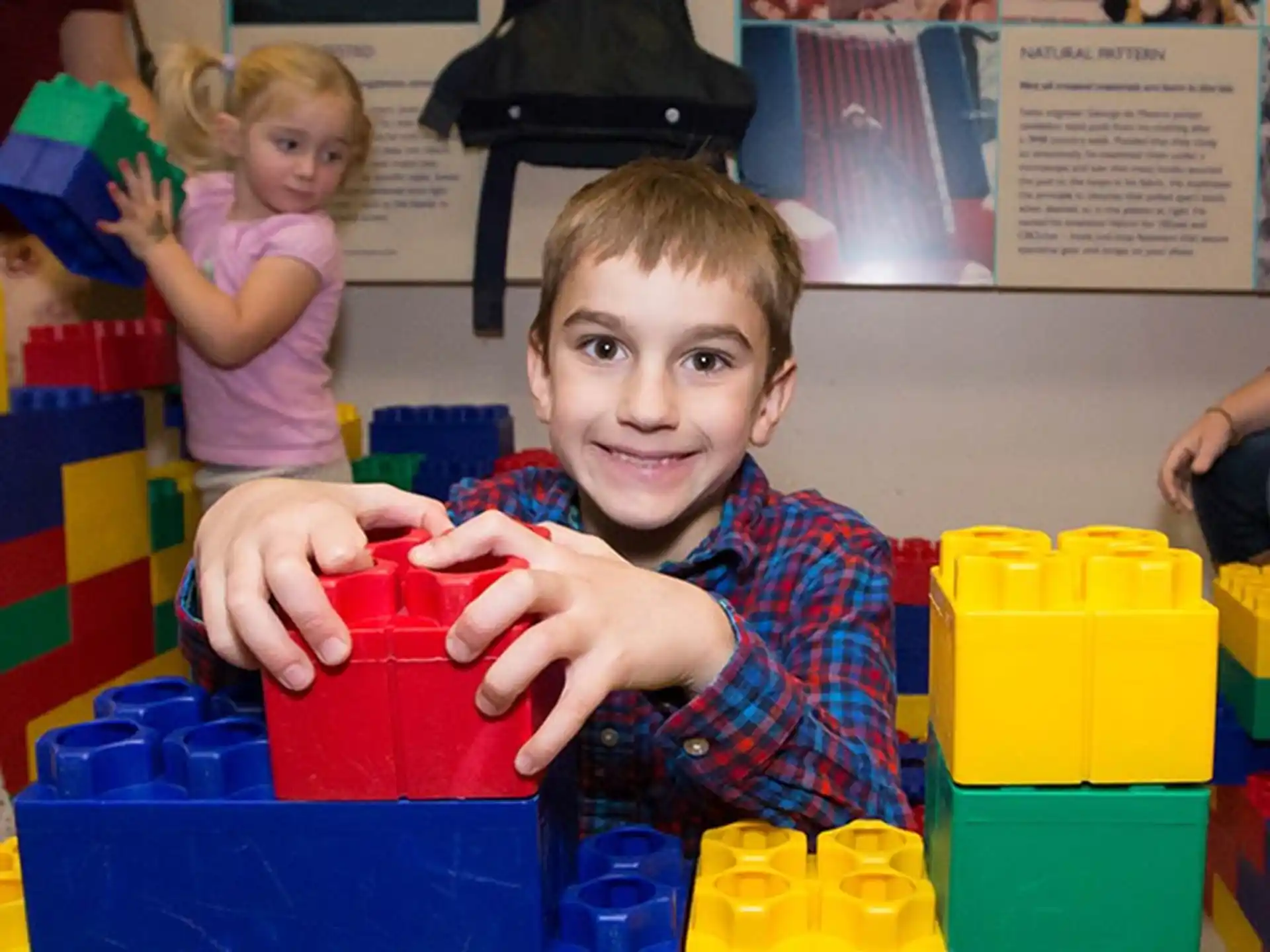a boy holding a red bucket