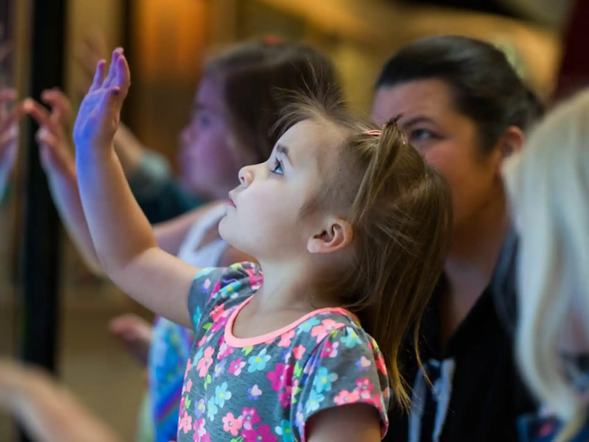 a young girl with her hands up