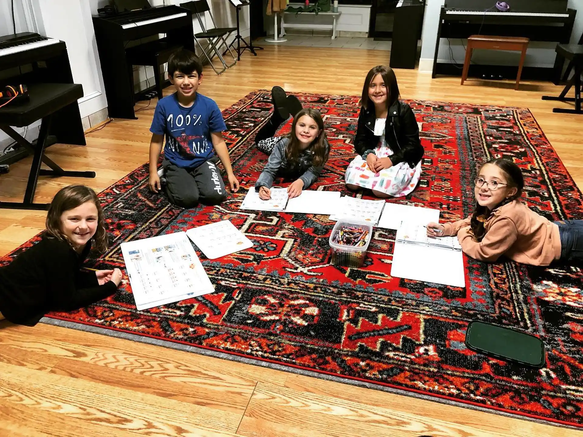 a group of people sitting on the floor with a board game