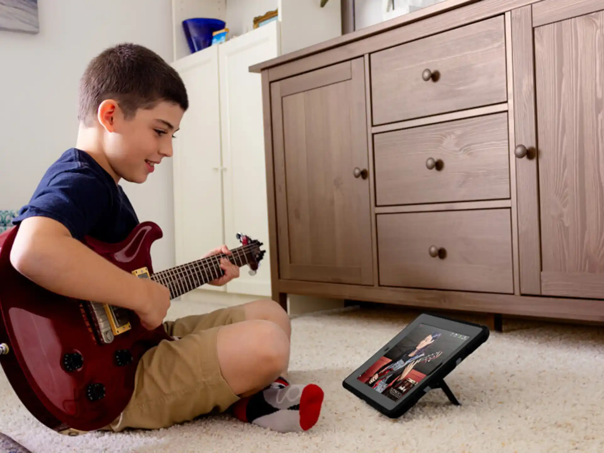 a boy playing a guitar