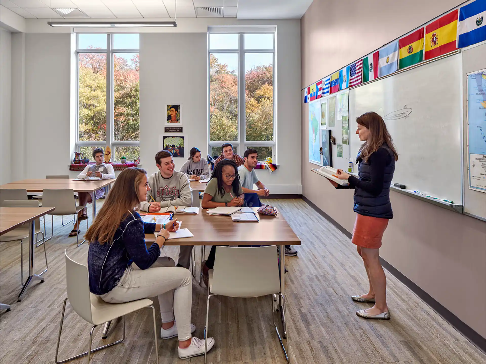 a person standing in front of a table with people sitting at it