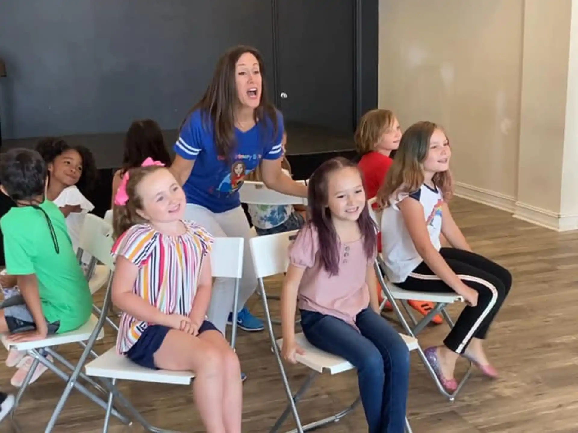 a group of children sitting in chairs