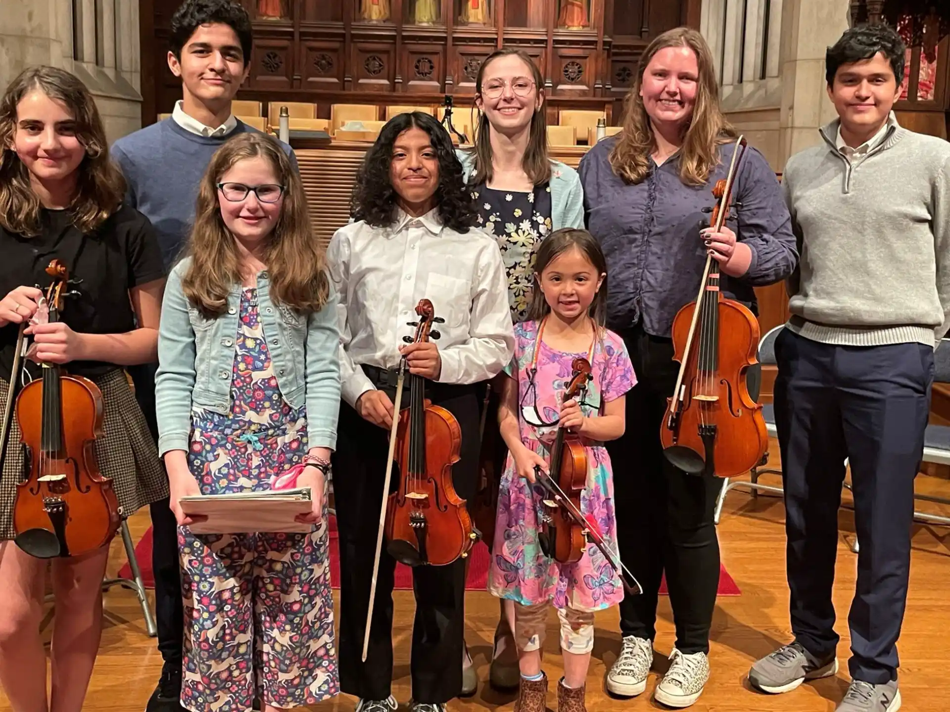 a group of people holding musical instruments