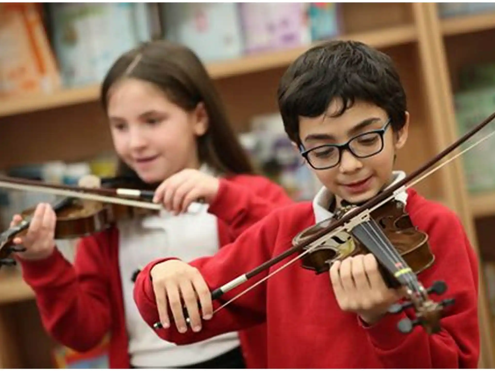a boy and girl playing violin