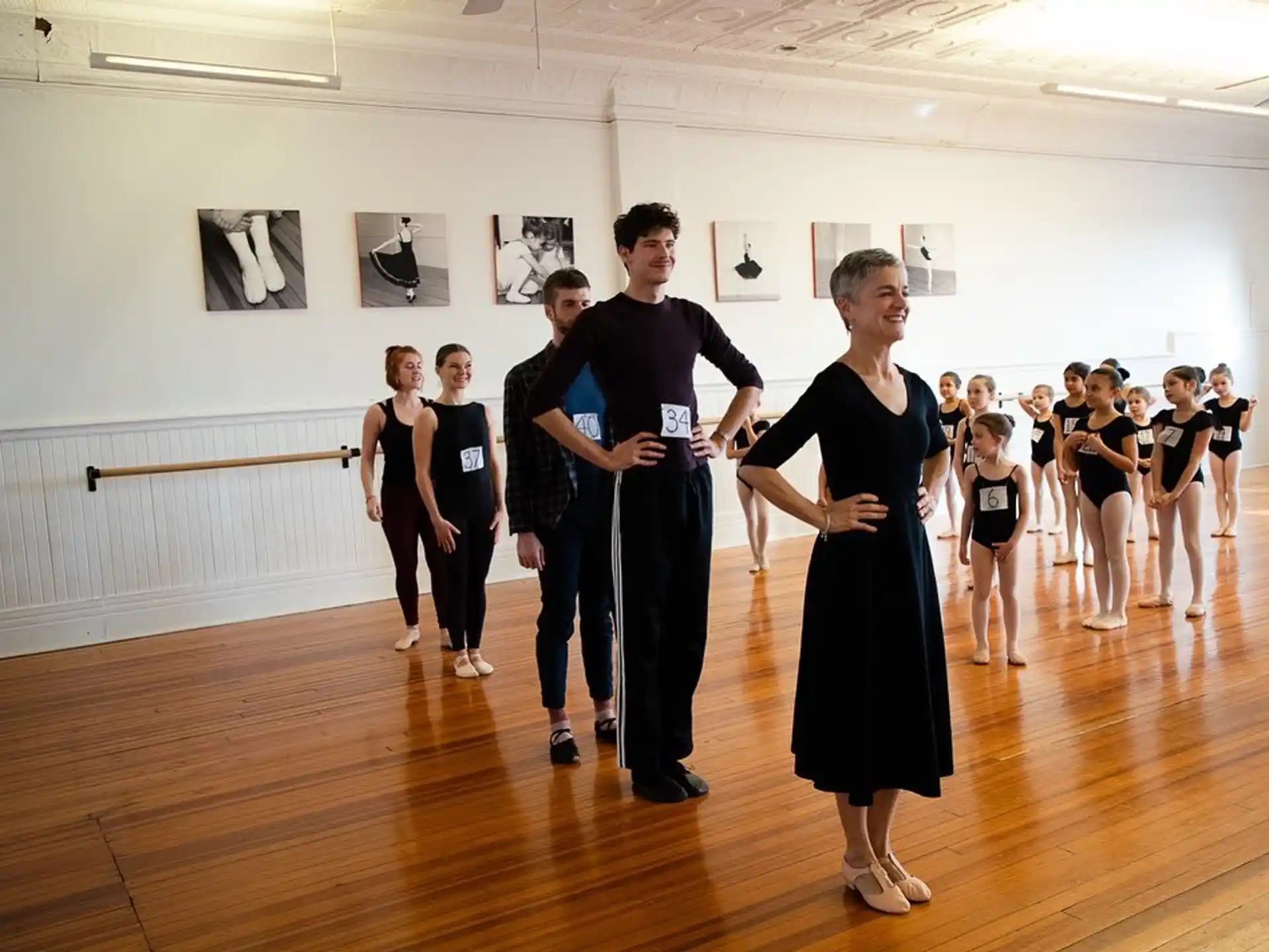 a man and woman dancing in a room with a group of people