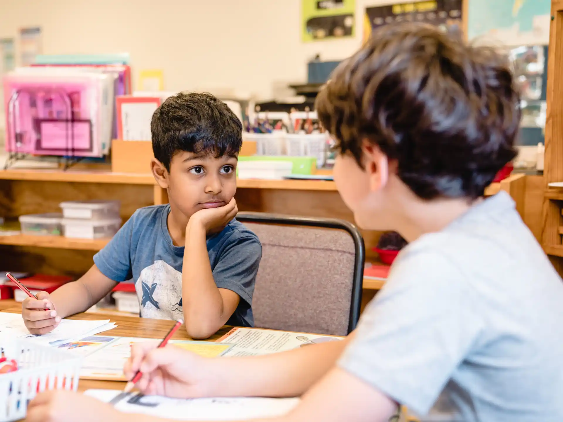 a person and a boy sitting at a table