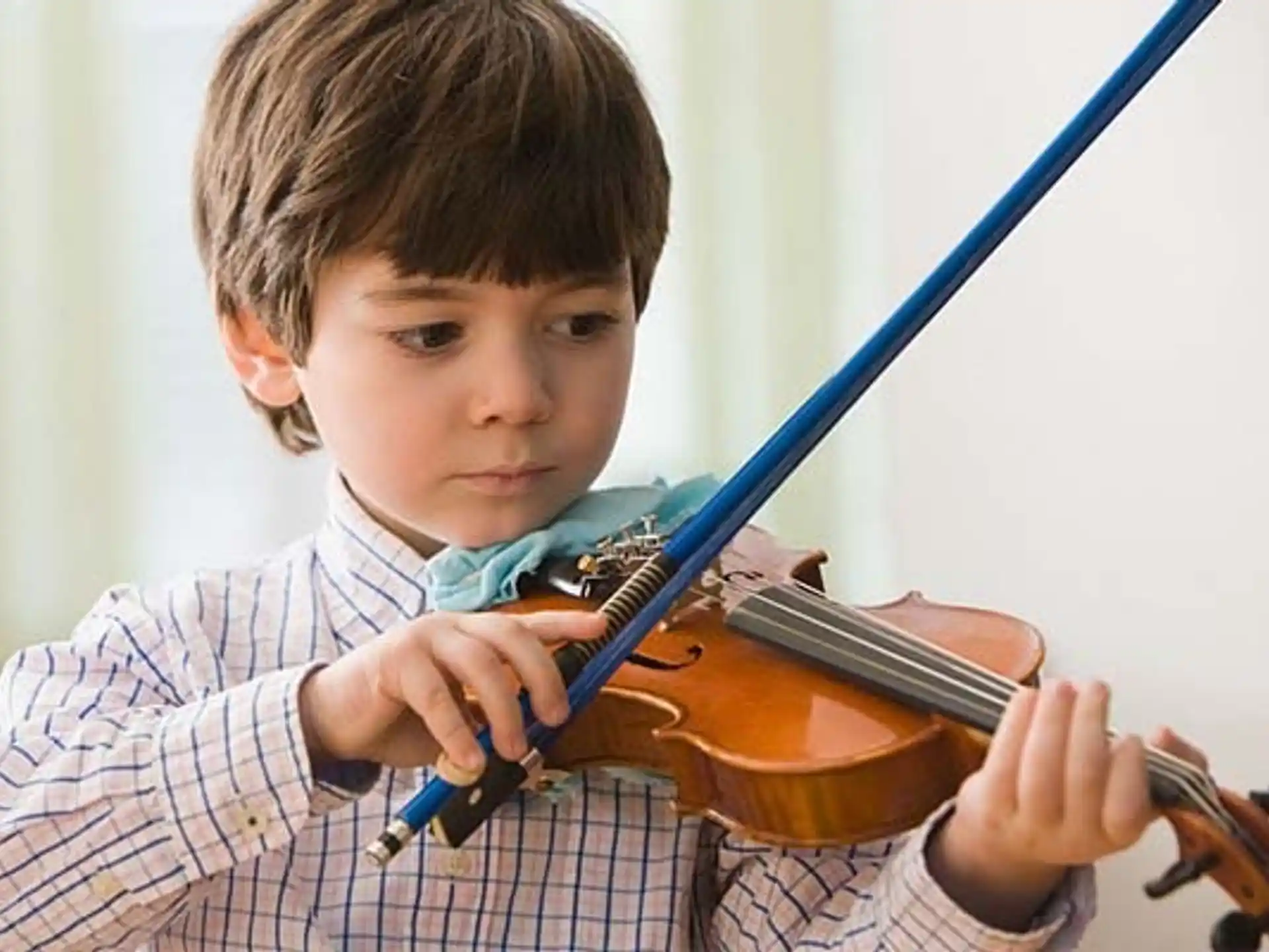 a boy playing a violin