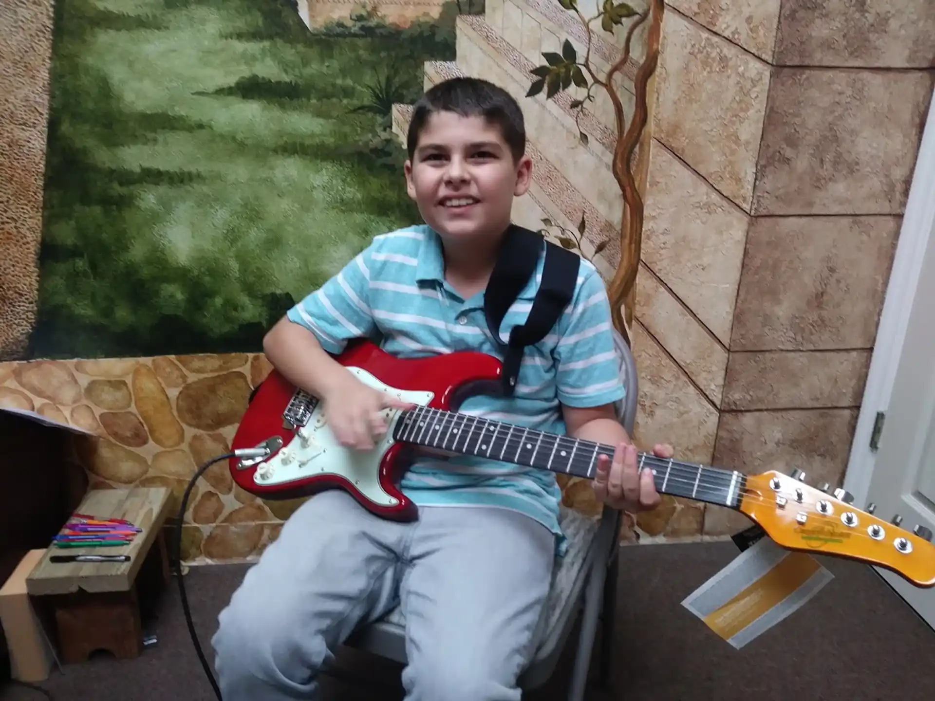 a boy holding a guitar