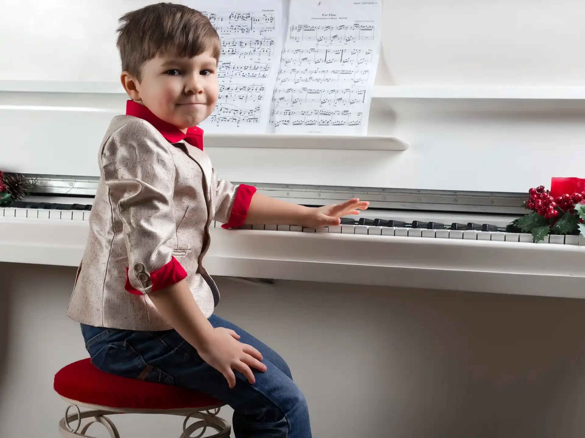 a boy sitting on a stool