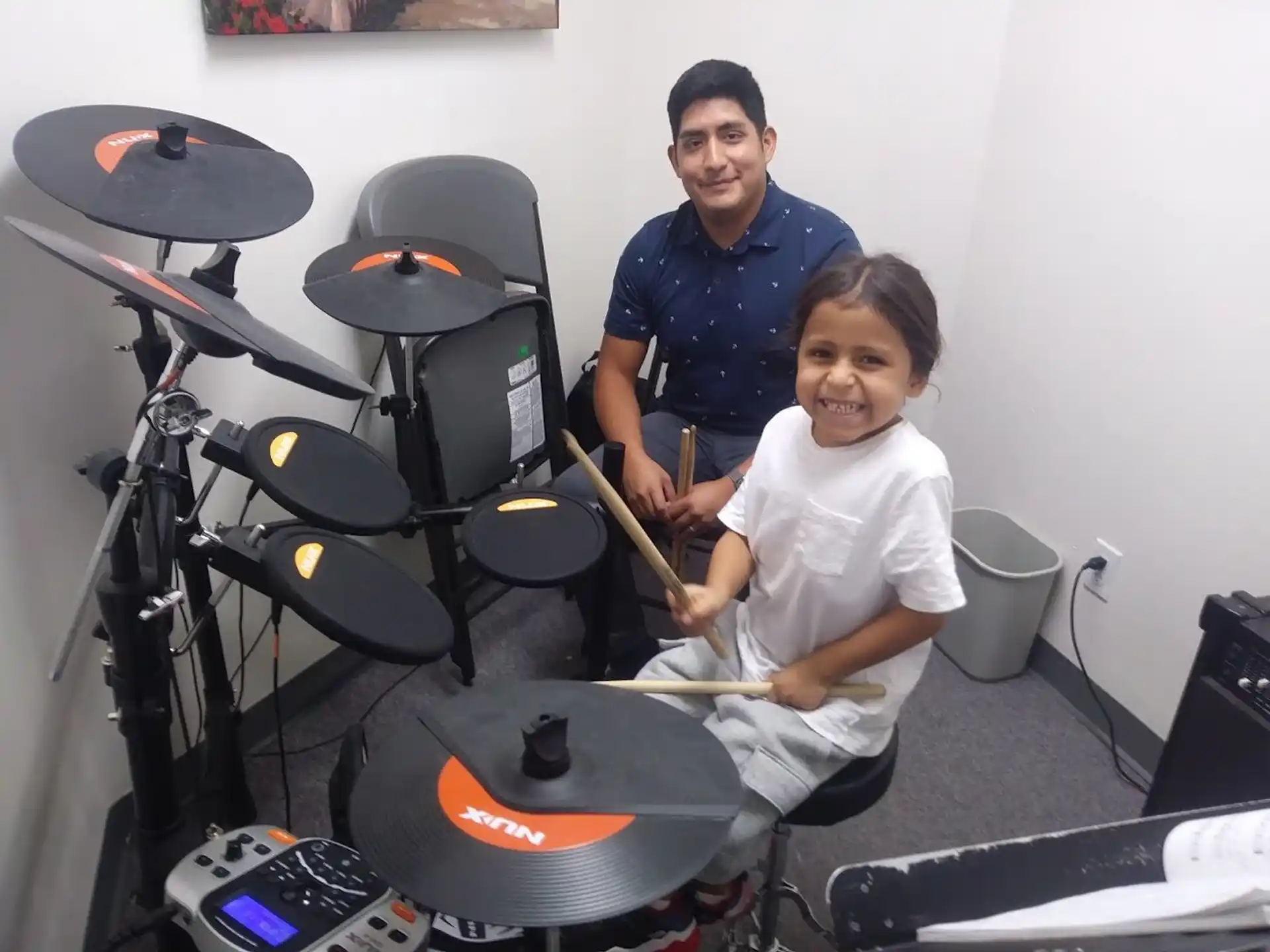 a man and a woman playing drums