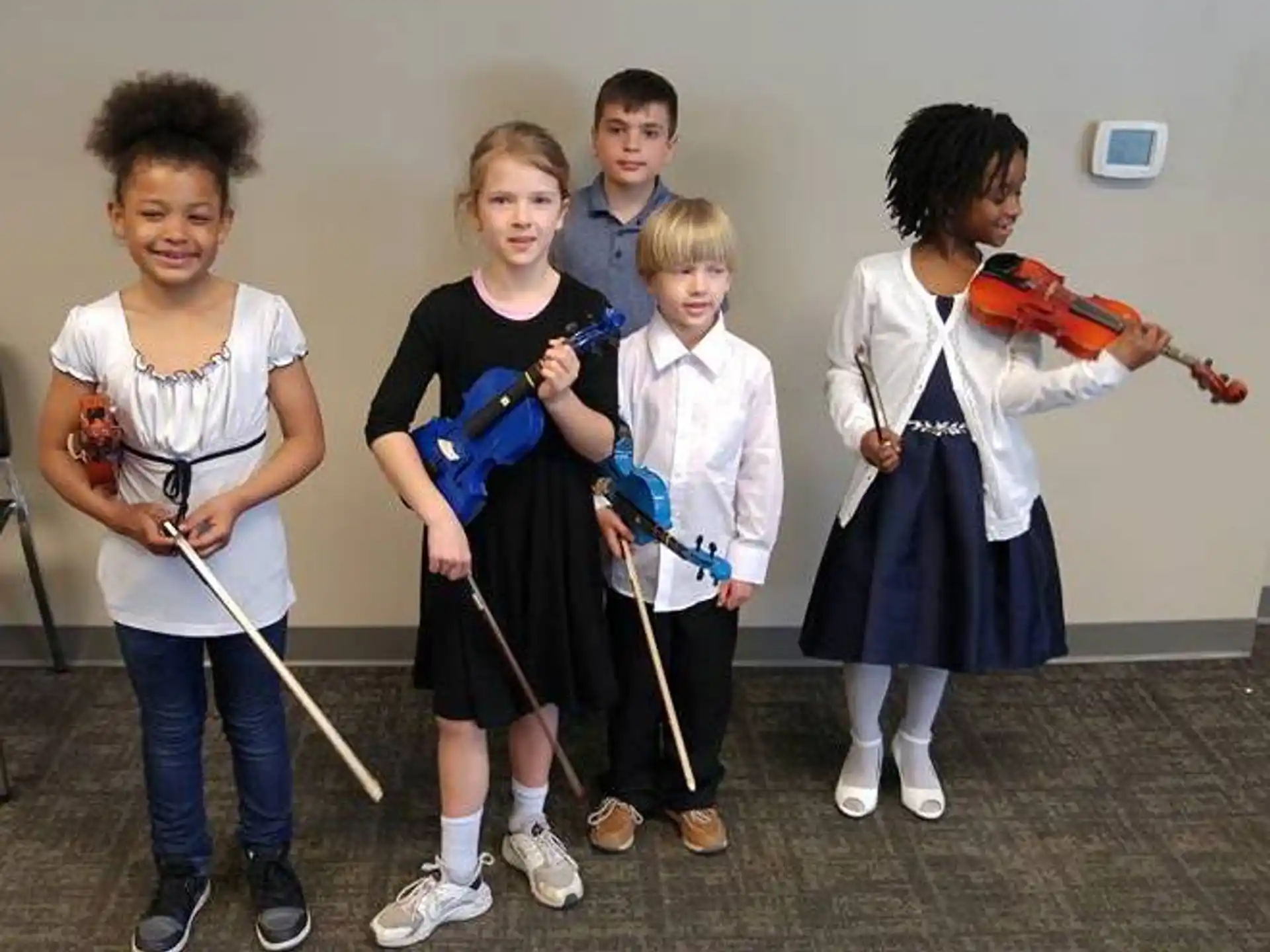 a group of children holding brooms