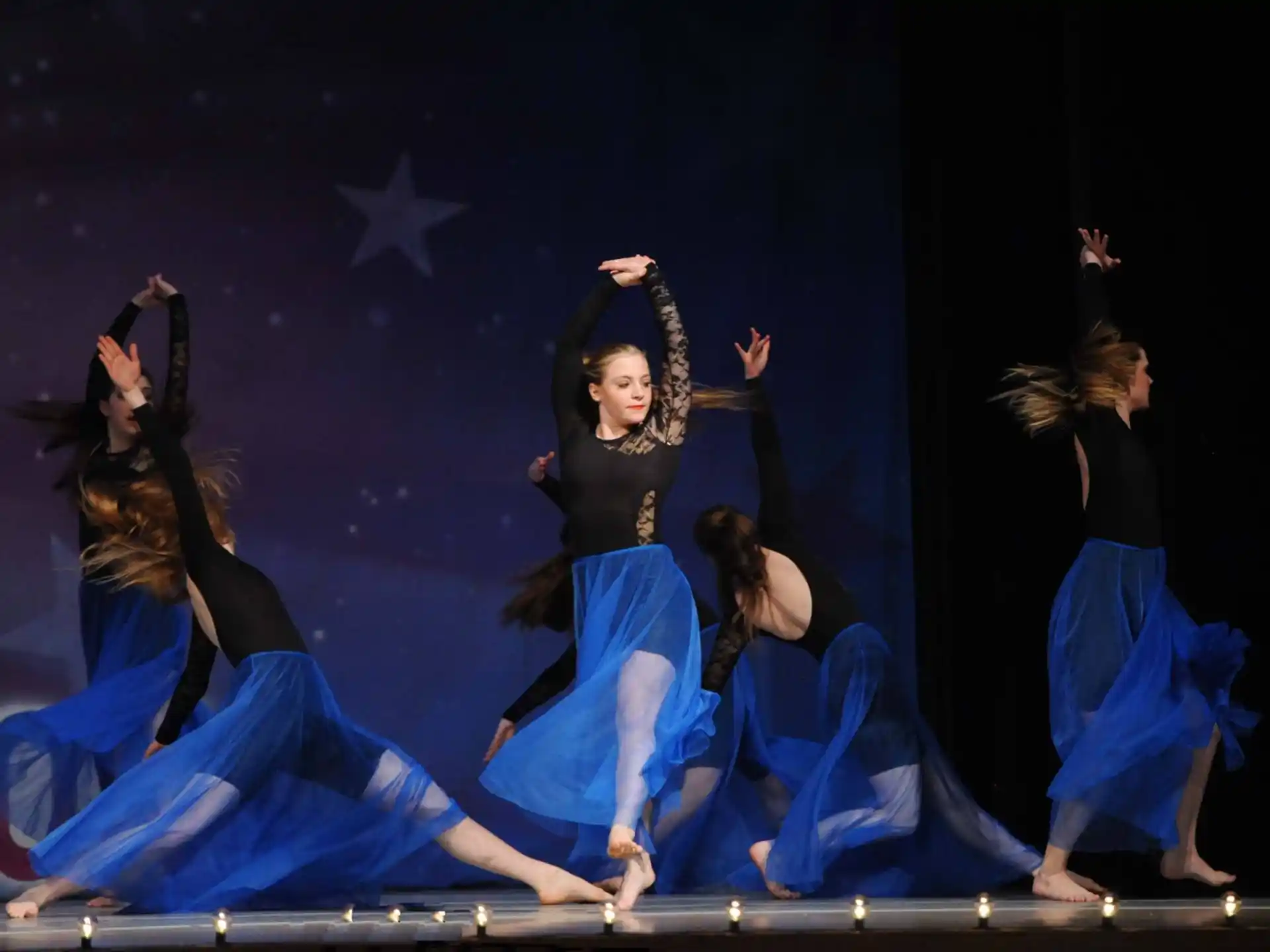 a group of women dancing on a stage