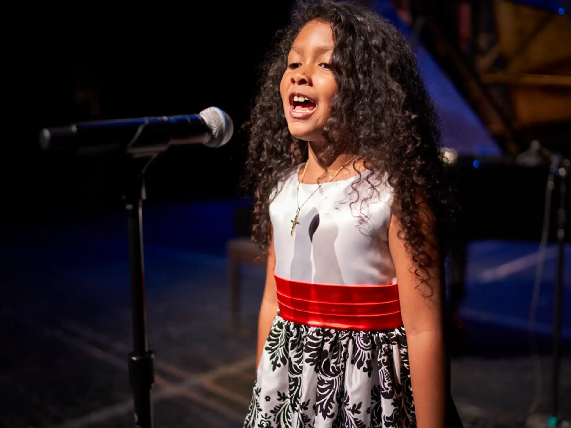 a woman singing into a microphone
