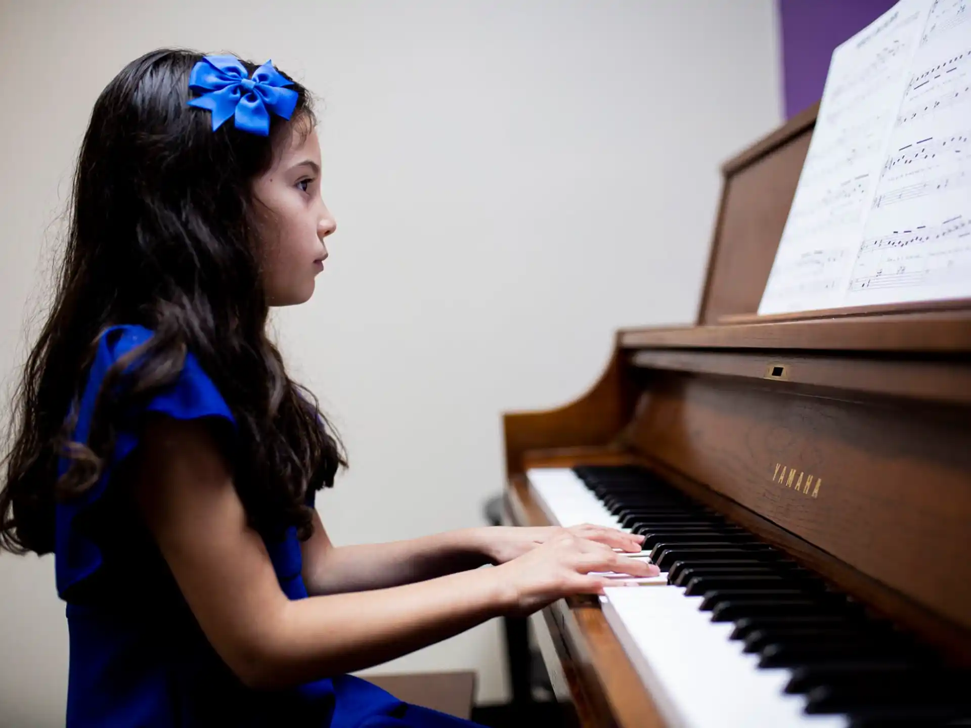 a woman playing a piano