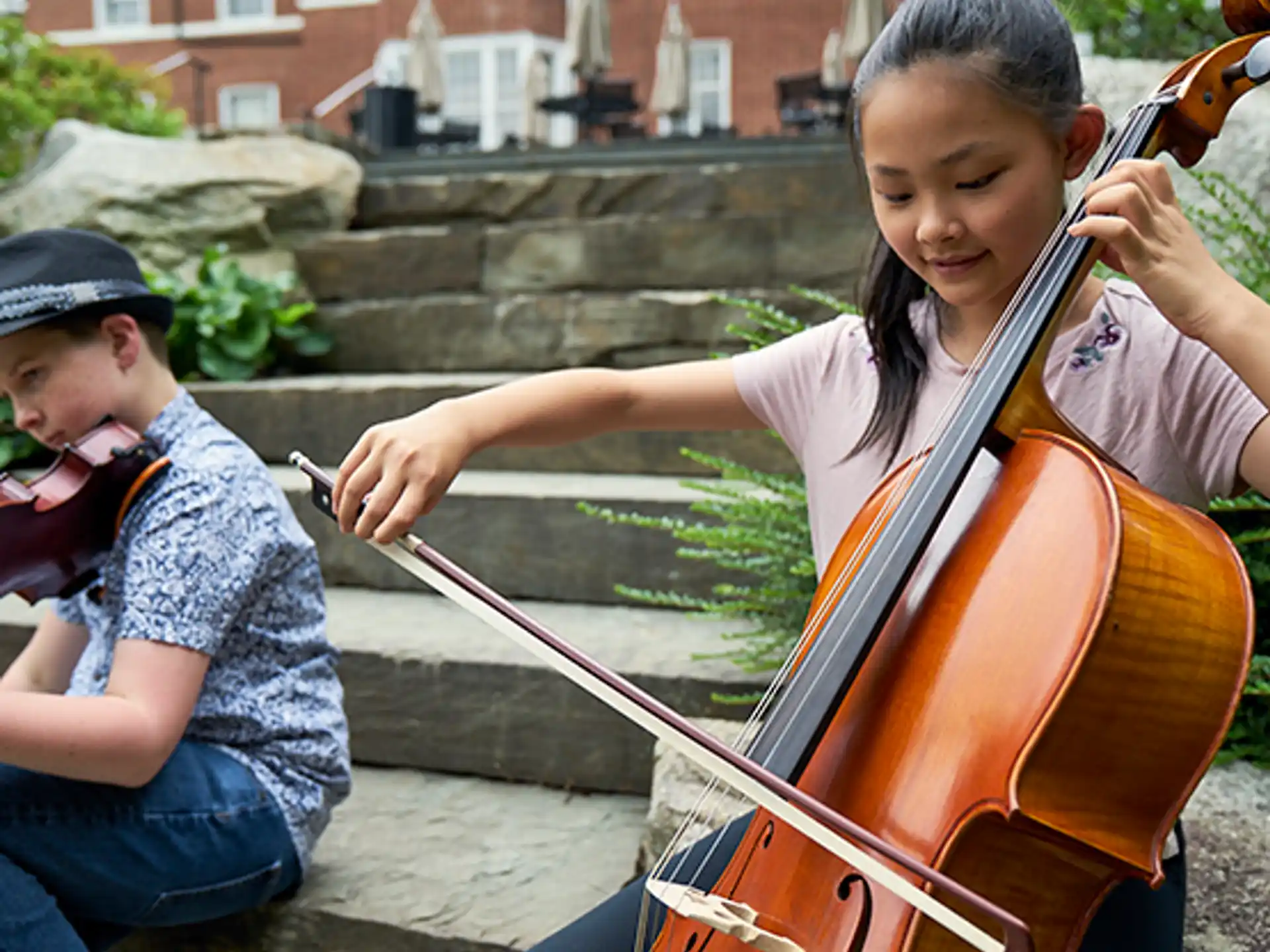 a boy and girl playing a violin