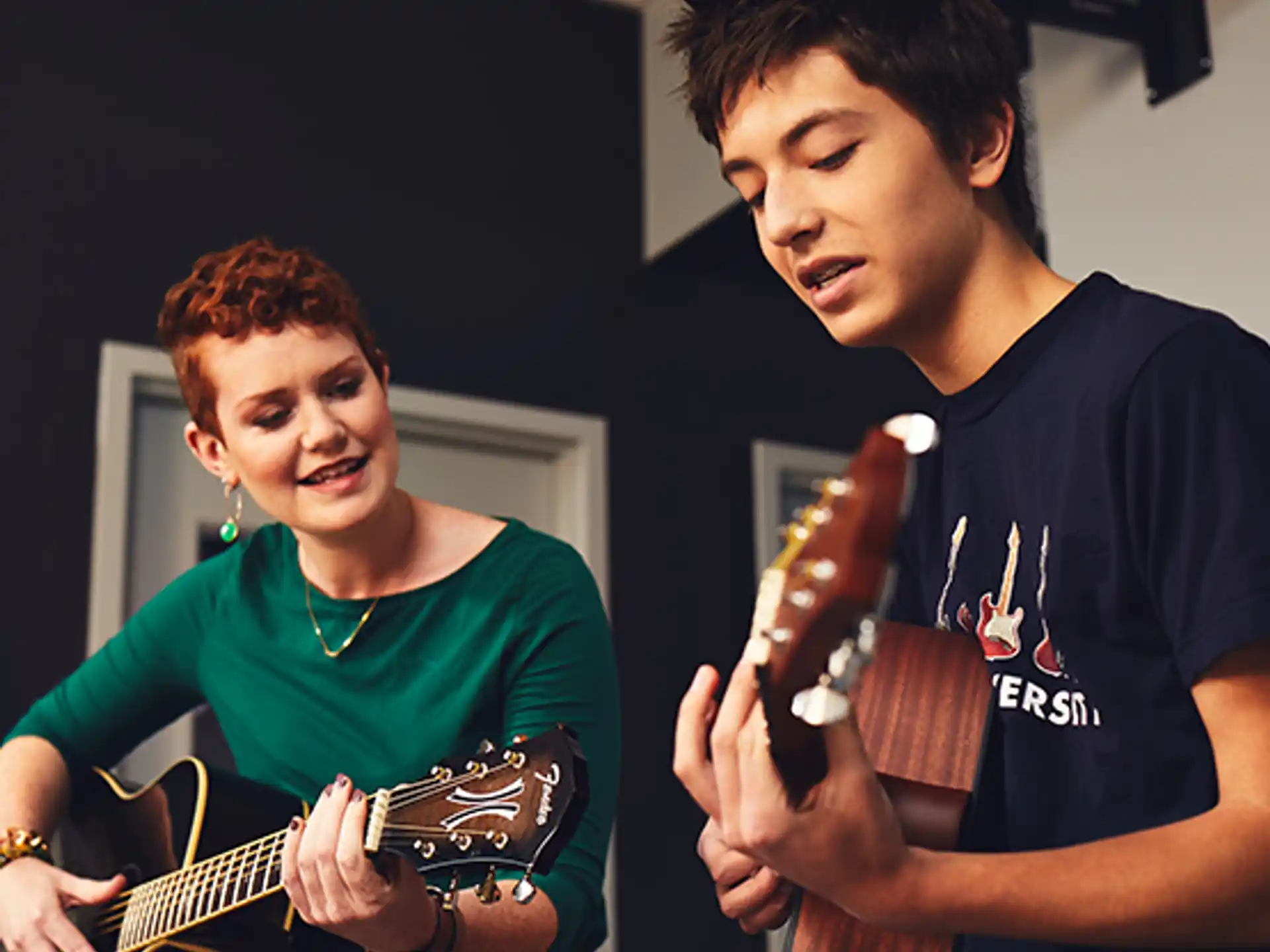 a man and a woman playing guitar