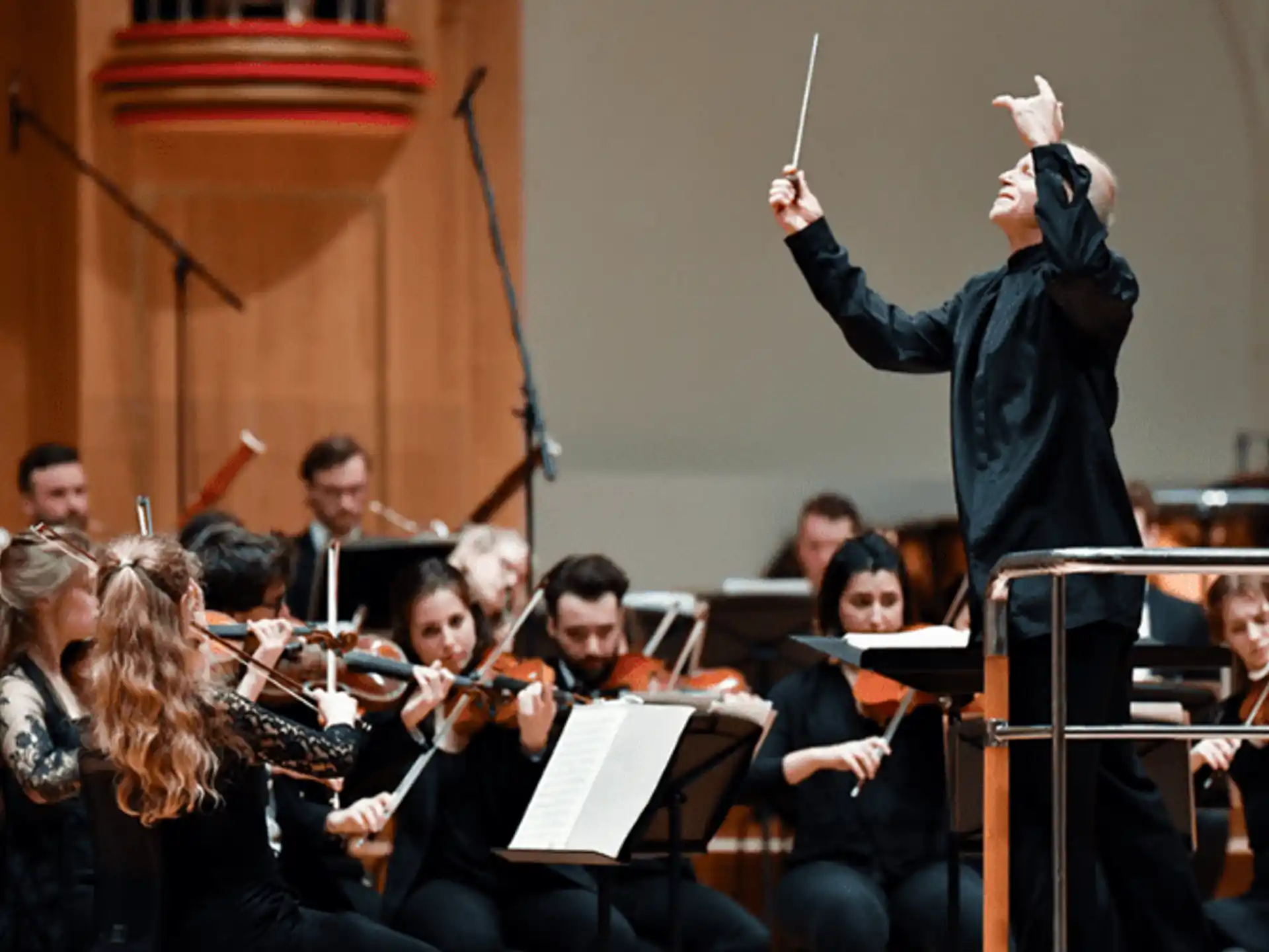 a person standing in front of an orchestra