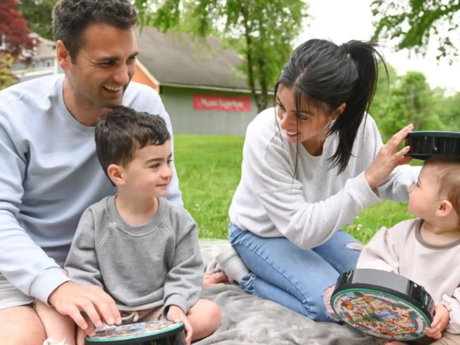 a family sitting on a blanket