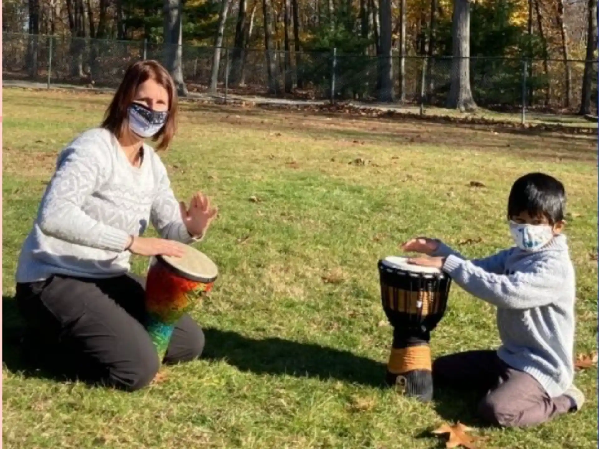 a person and a boy with a gas mask and a fire extinguisher in a grassy
