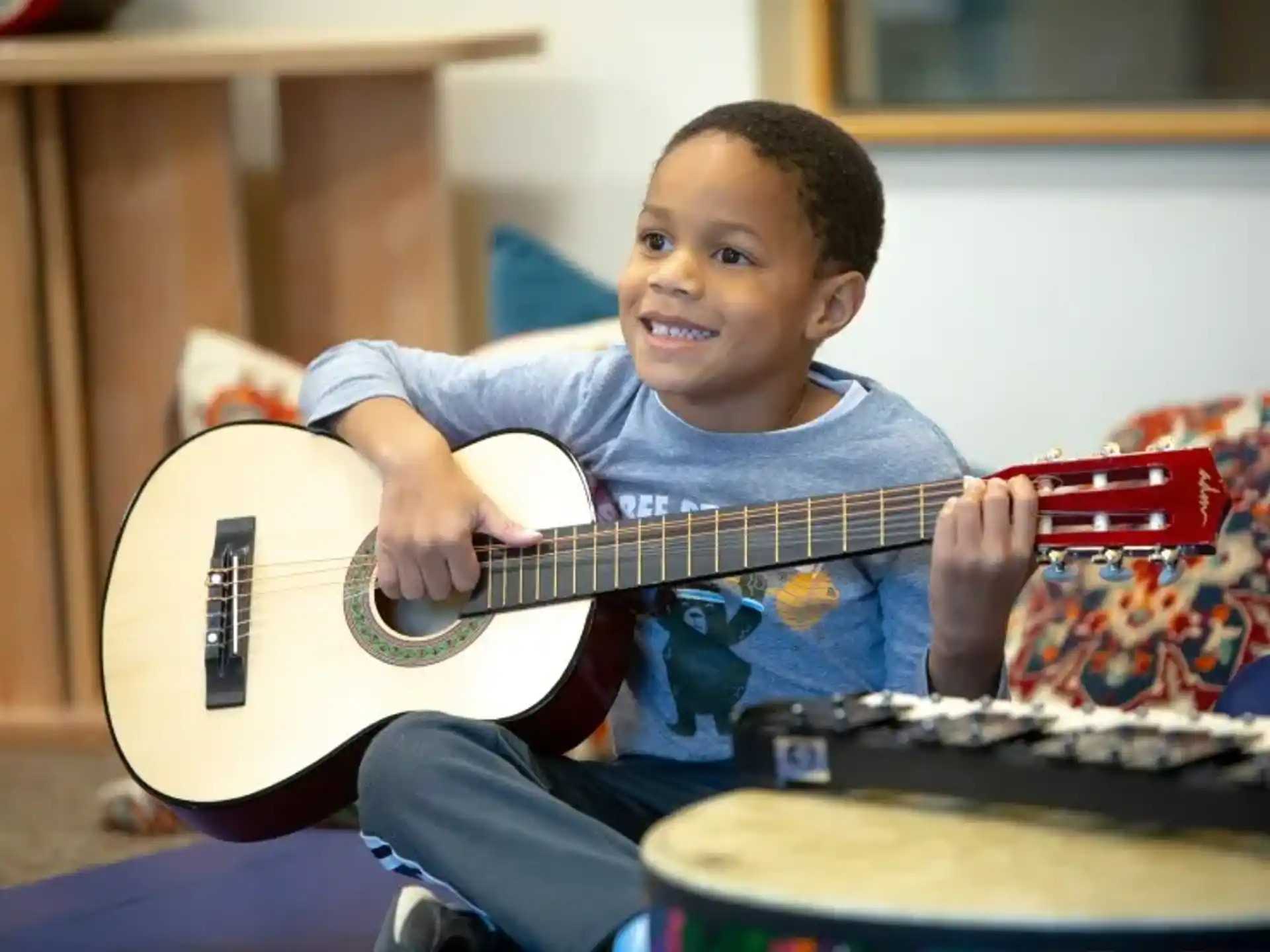 a boy playing a guitar