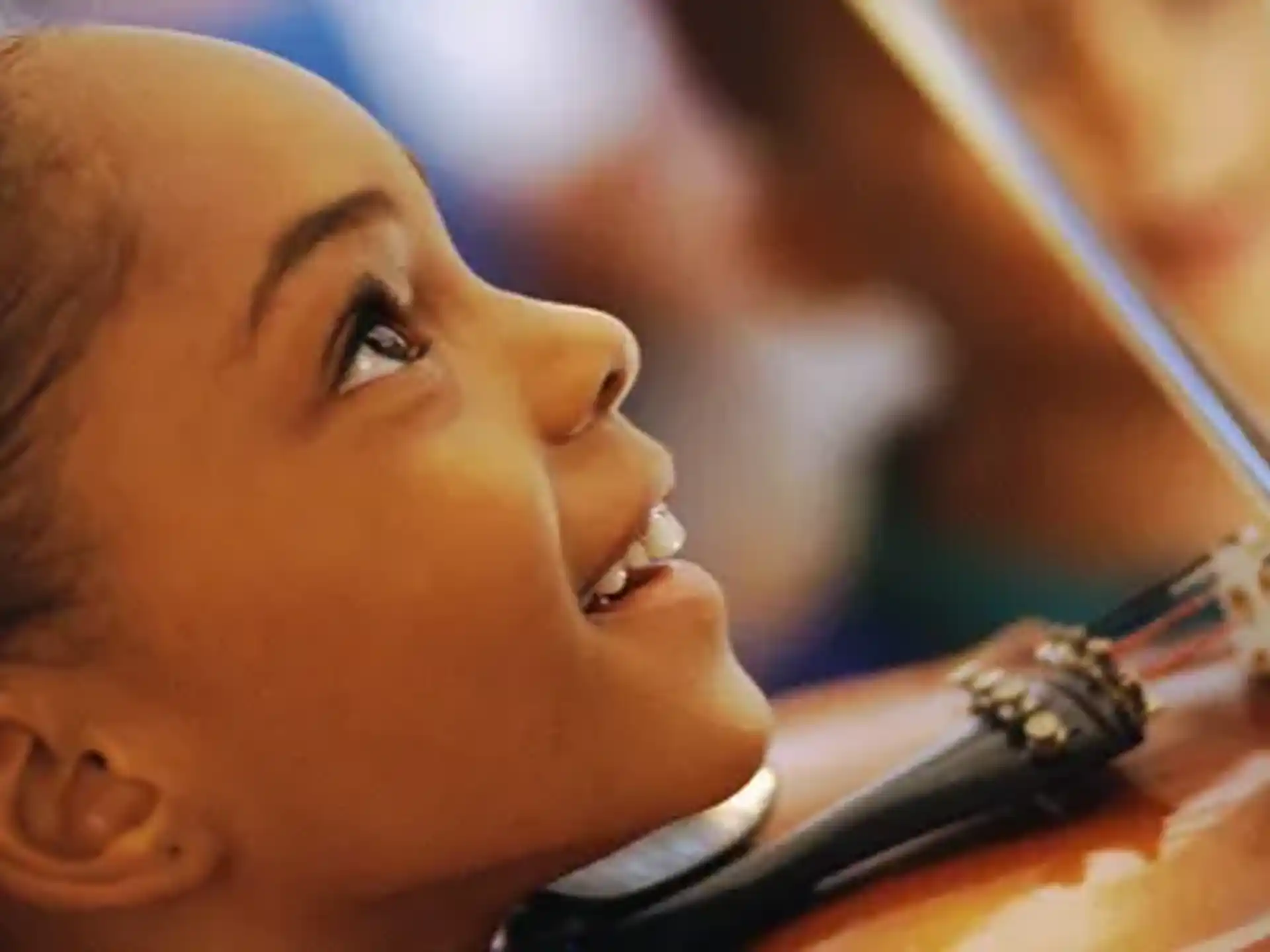 a close-up of a person playing a violin