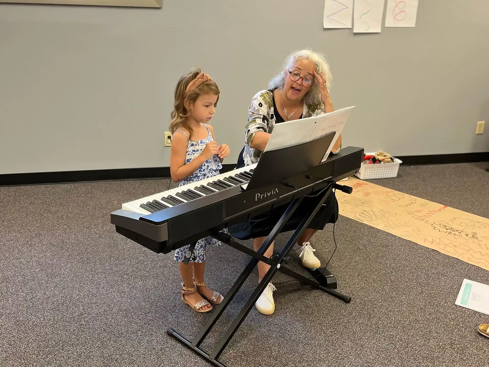 a person and a child playing piano