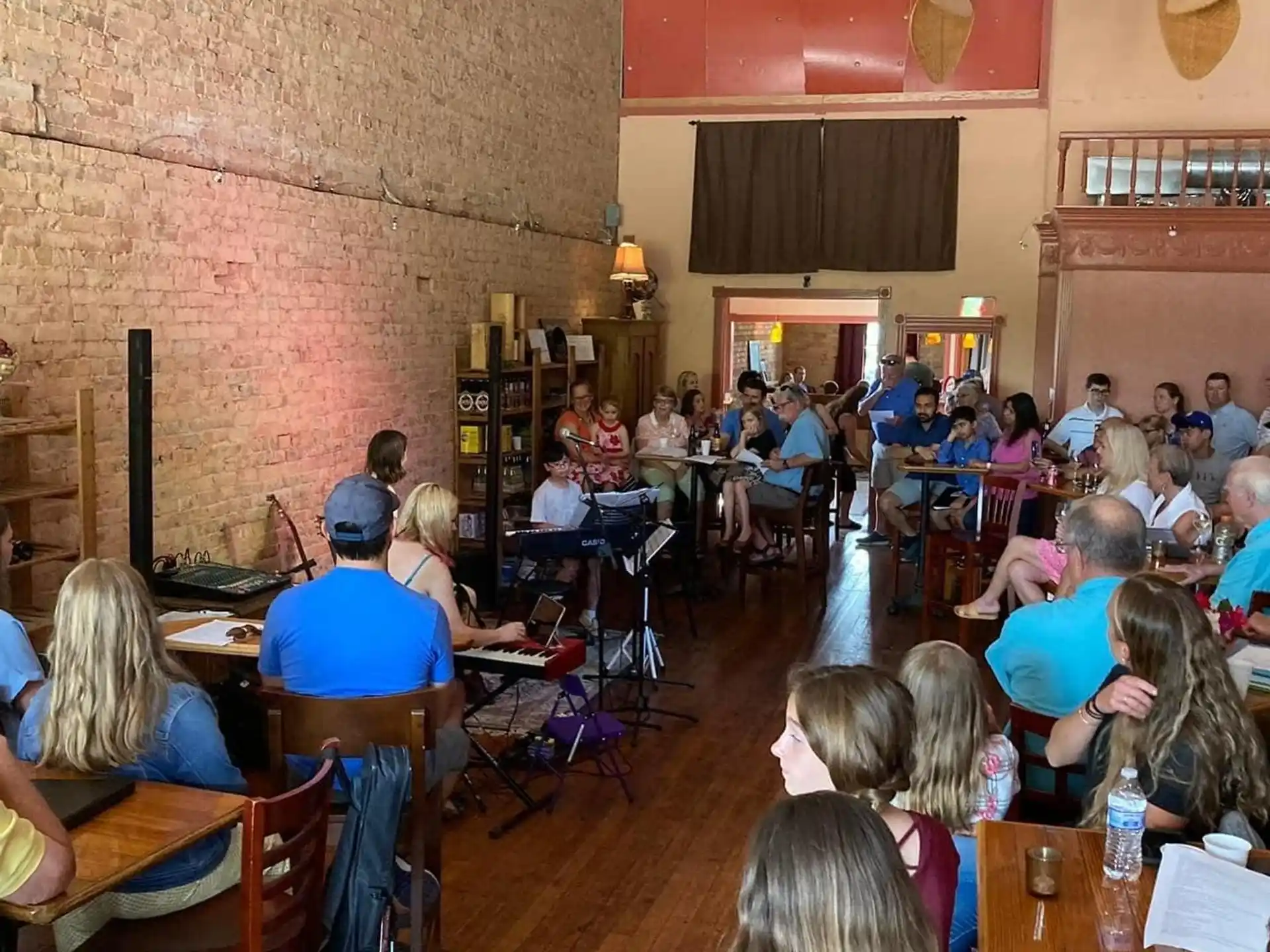 a group of people sitting in a room with instruments