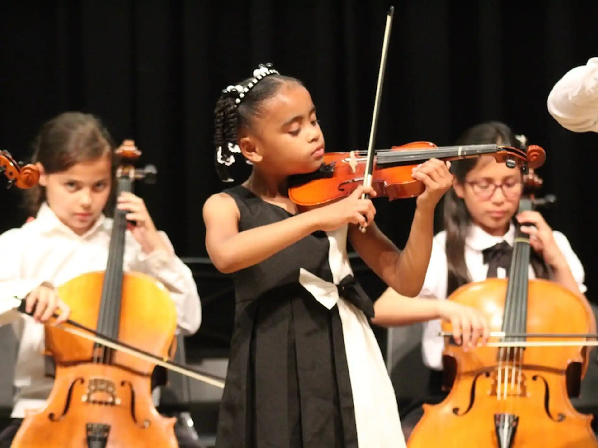 a group of kids playing violin