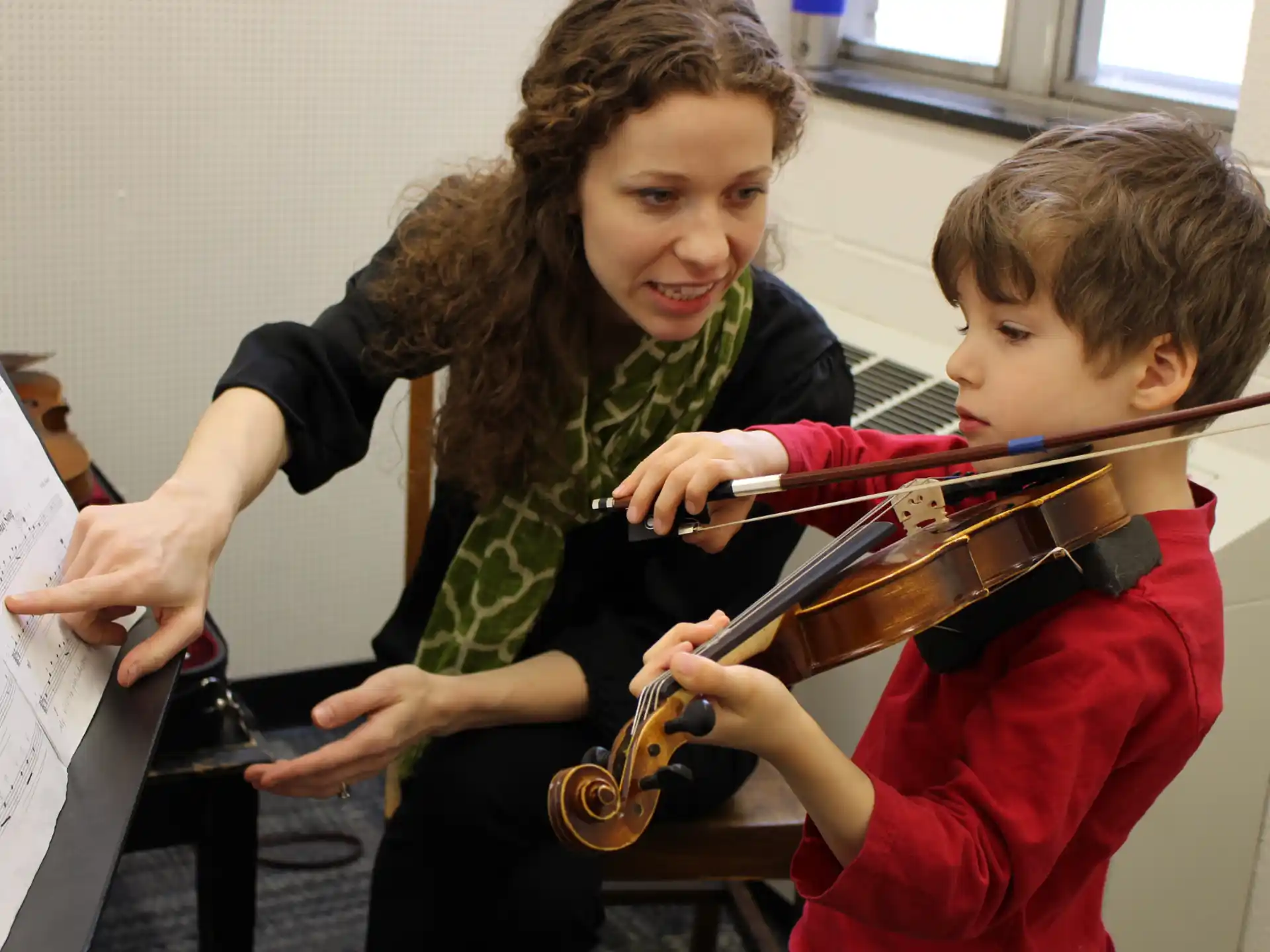 a person and a boy playing violin