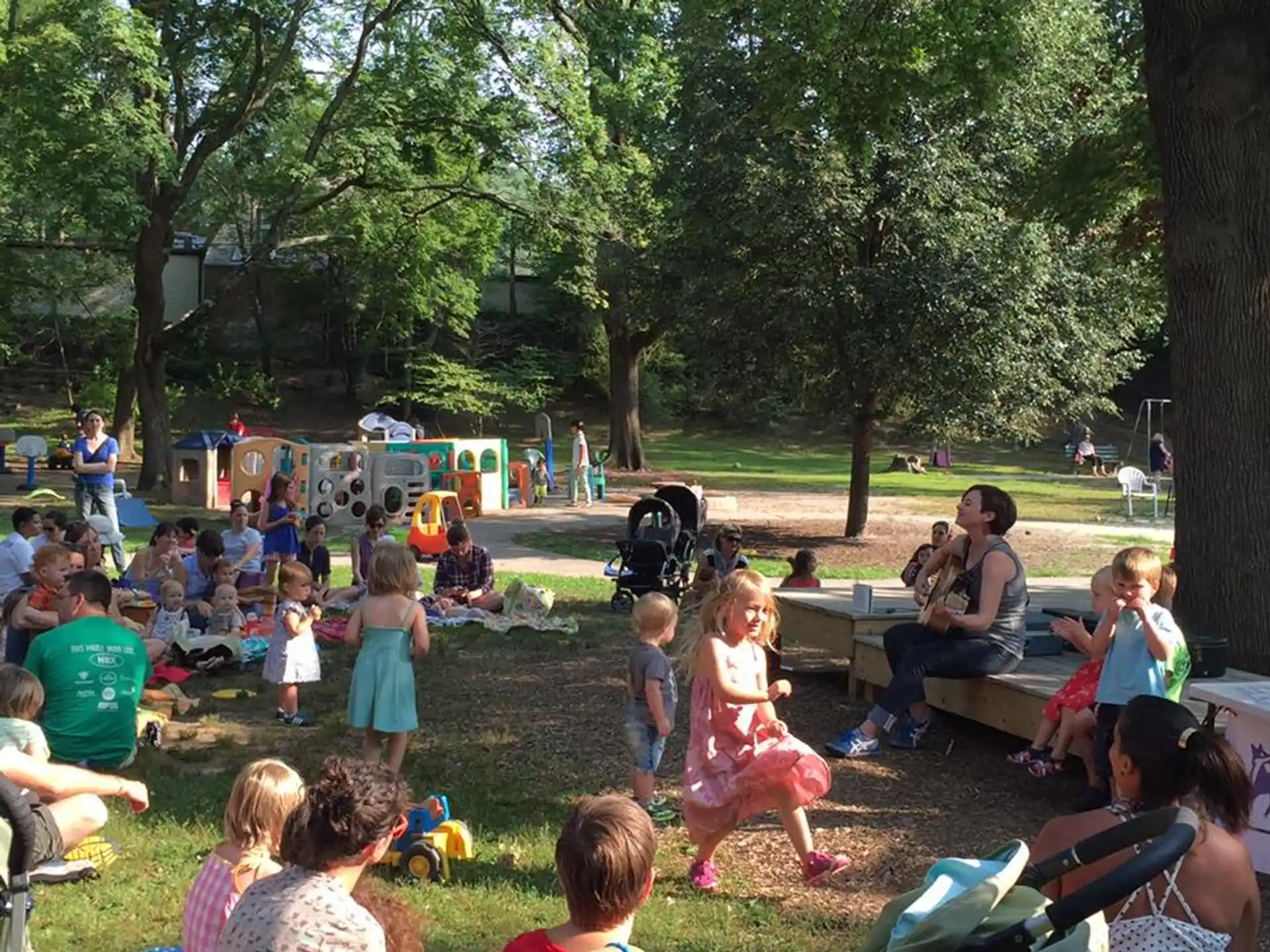 a group of people sitting on the grass